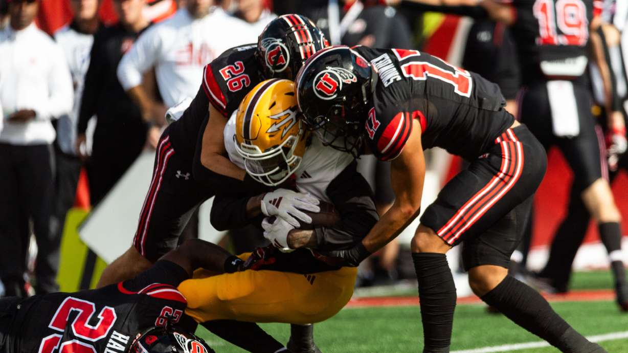 Arizona State Sun Devils wide receiver Elijhah Badger is tackled by Utah Utes safety Briton Allen, left, and Utah Utes cornerback Smith Snowden, right, at Rice-Eccles Stadium in Salt Lake City on Saturday, Nov. 4, 2023.