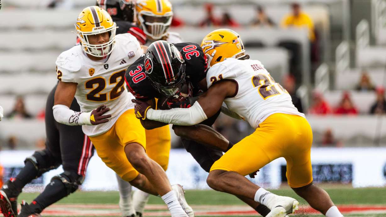 Utah Utes safety Ben Durham is tackled by Arizona State Sun Devils defensive back RJ Regan at Rice-Eccles Stadium in Salt Lake City on Saturday, Nov. 4, 2023.