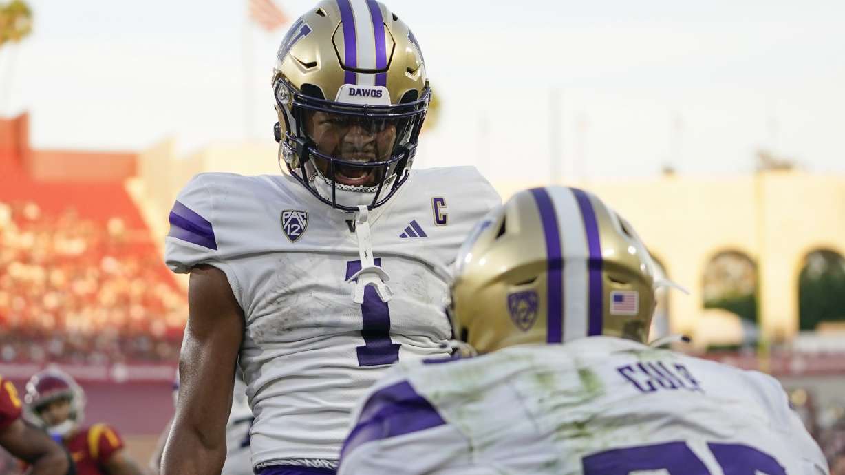 Washington wide receiver Rome Odunze, rear, celebrates a touchdown by tight end Devin Culp, front, during the first half of the team's NCAA college football game against Southern California, Saturday, Nov. 4, 2023, in Los Angeles.