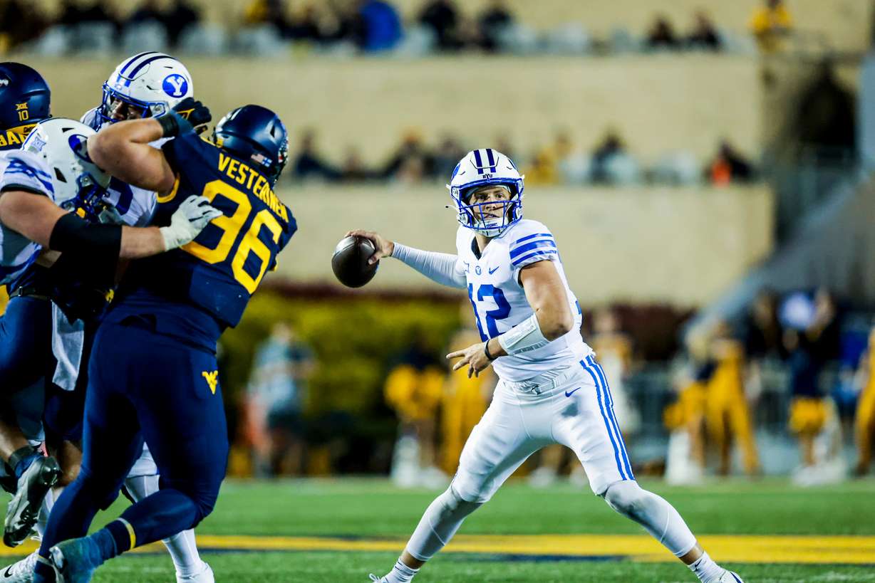 BYU quarterback Jake Retzlaff throws downfield during a game against West Virginia, Saturday, Nov. 4, 2023, in Morgantown, W. Va. BYU lost, 37-7.