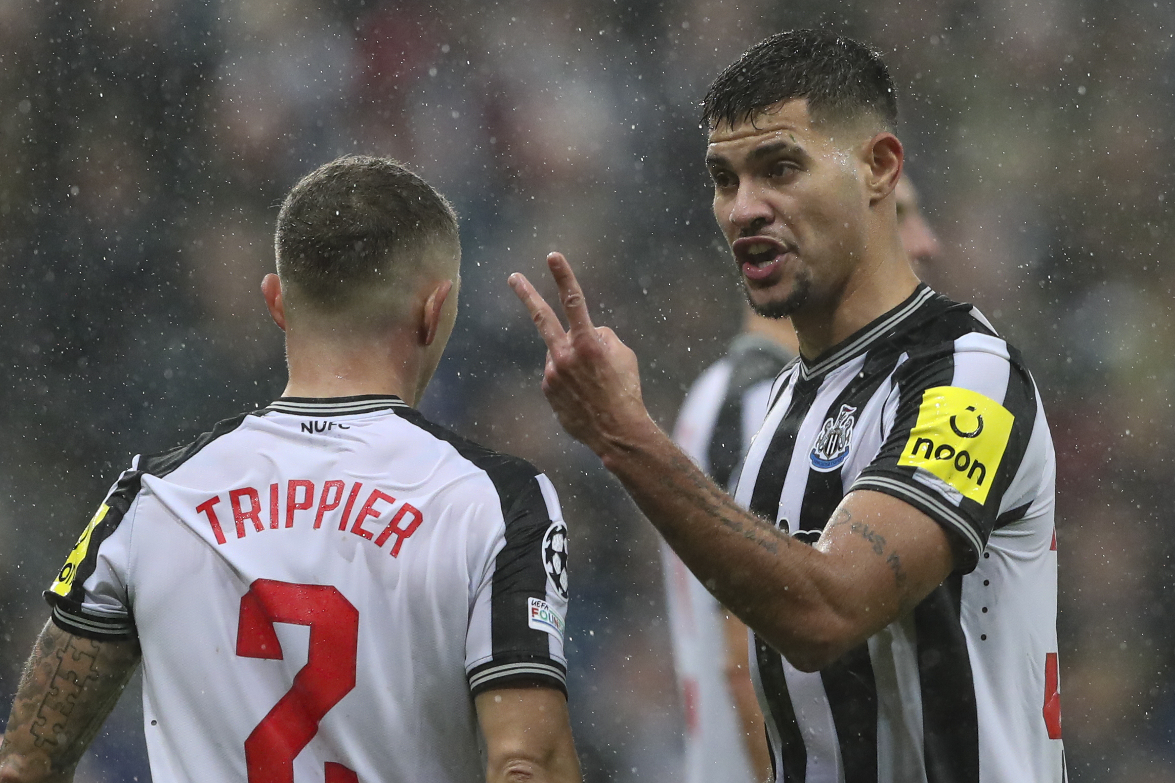 Newcastle's Bruno Guimaraes, right, speaks with Newcastle's Kieran Trippier during the Champions League group F soccer match between Newcastle and Dortmund at St. James' Park, in Newcastle, England, Wednesday, Oct. 25, 2023. 
