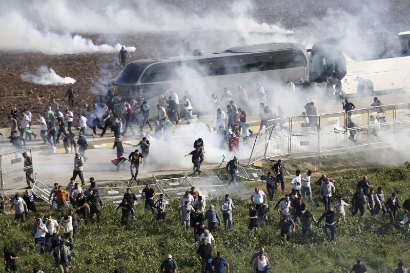 People clash with anti-riot Turkish police officers during a pro-Palestine protest outside U.S.-Turkish Incirlik military air base in Adana, southern Turkey, Sunday.