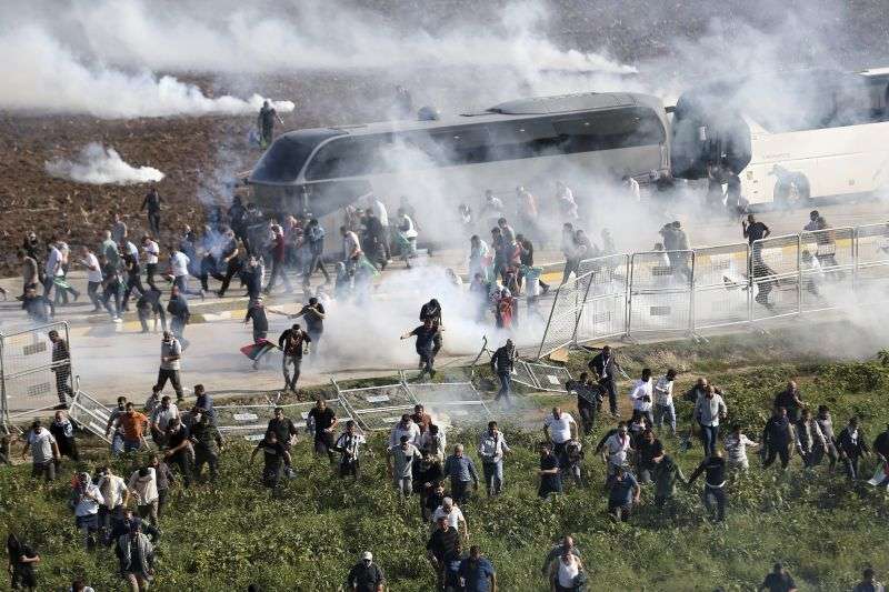 People clash with anti-riot Turkish police officers during a pro-Palestine protest outside U.S.-Turkish Incirlik military air base in Adana, southern Turkey, Sunday.