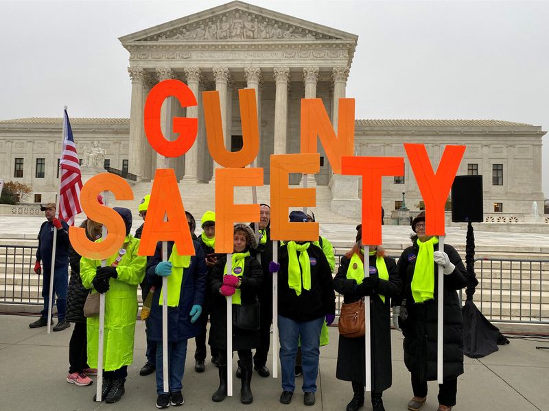 A group among hundreds of supporters of gun control laws rally in front of the Supreme Court as the justices hear the first major gun rights case since 2010, in Washington, Dec. 2, 2019. The court is set to examine a gun case Tuesday.