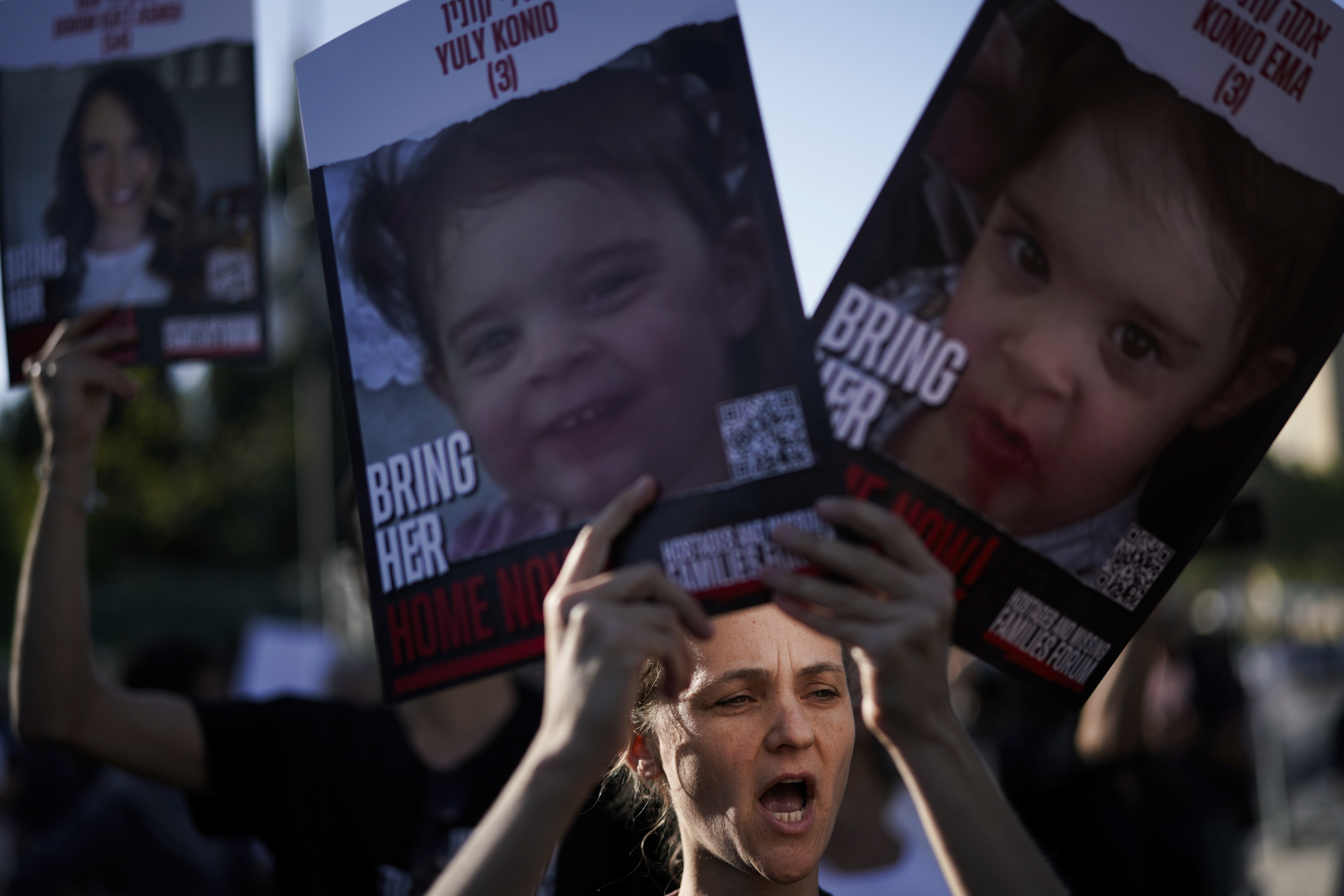 Relatives and friends of those kidnapped during the Oct. 7 Hamas bloody cross-border attack in Israel, hold photos of their loved ones during a protest calling for their return outside the Knesset, Israel's parliament in Jerusalem Monday.