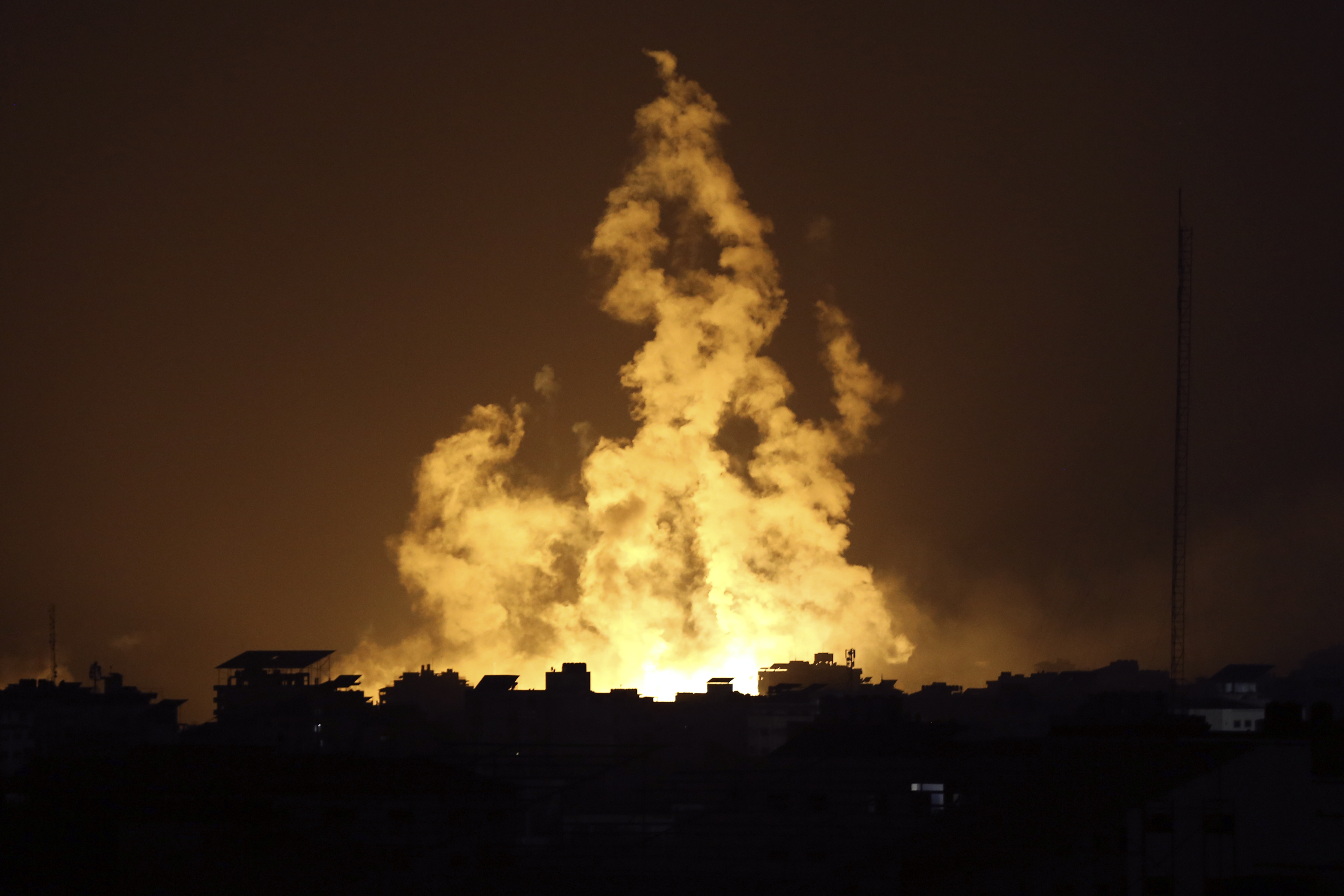 Fire and smoke rises from buildings following Israeli airstrikes on Gaza City, Sunday.