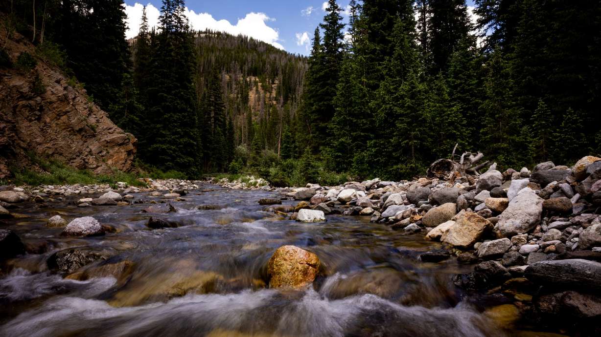 The Colorado River flows a few miles from its headwater in Rocky Mountain Park in Colorado on July 14, 2022. President Joe Biden says he has a plan with new money aimed at conservation for the river.