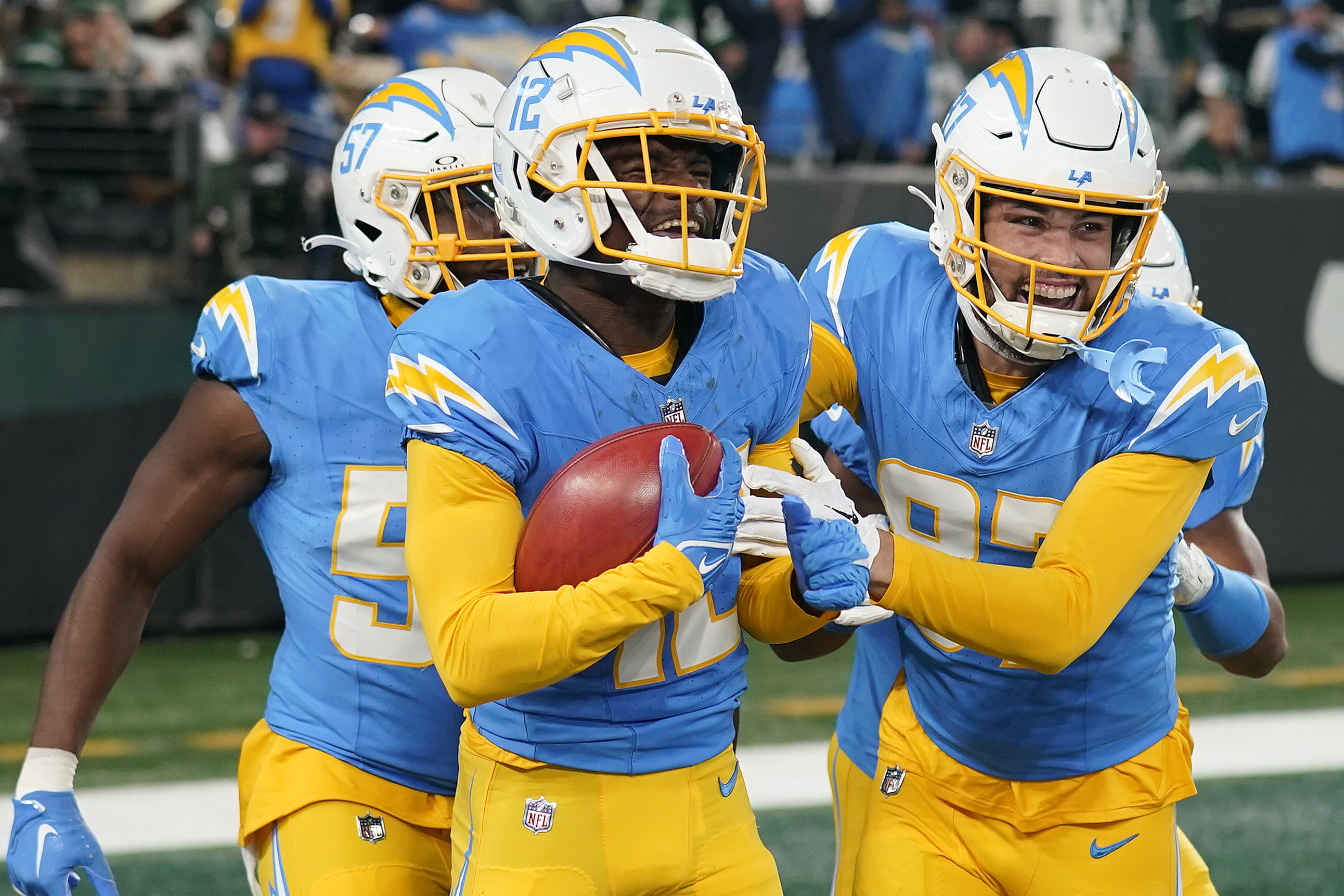 Los Angeles Chargers wide receiver Derius Davis, left, celebrates with teammates after scoring a touchdown against the New York Jets during the first quarter of an NFL football game, Monday, Nov. 6, 2023, in East Rutherford, N.J. 