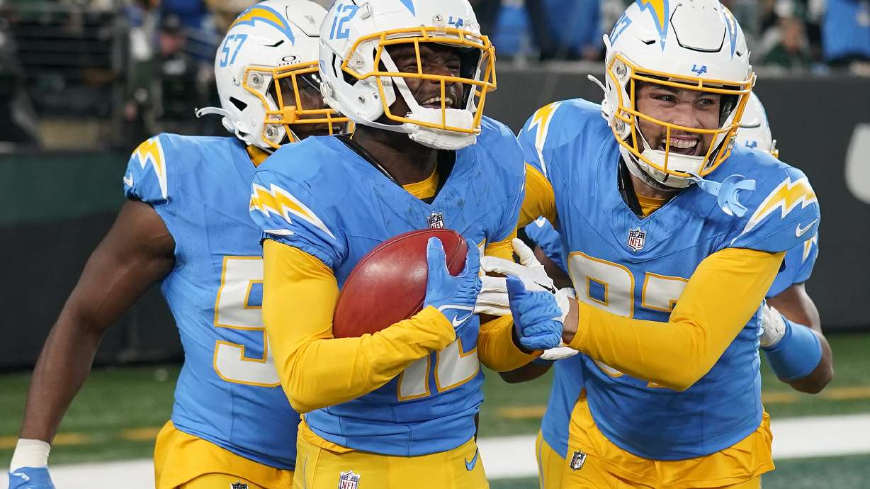 Los Angeles Chargers wide receiver Derius Davis, left, celebrates with teammates after scoring a touchdown against the New York Jets during the first quarter of an NFL football game, Monday, Nov. 6, 2023, in East Rutherford, N.J.