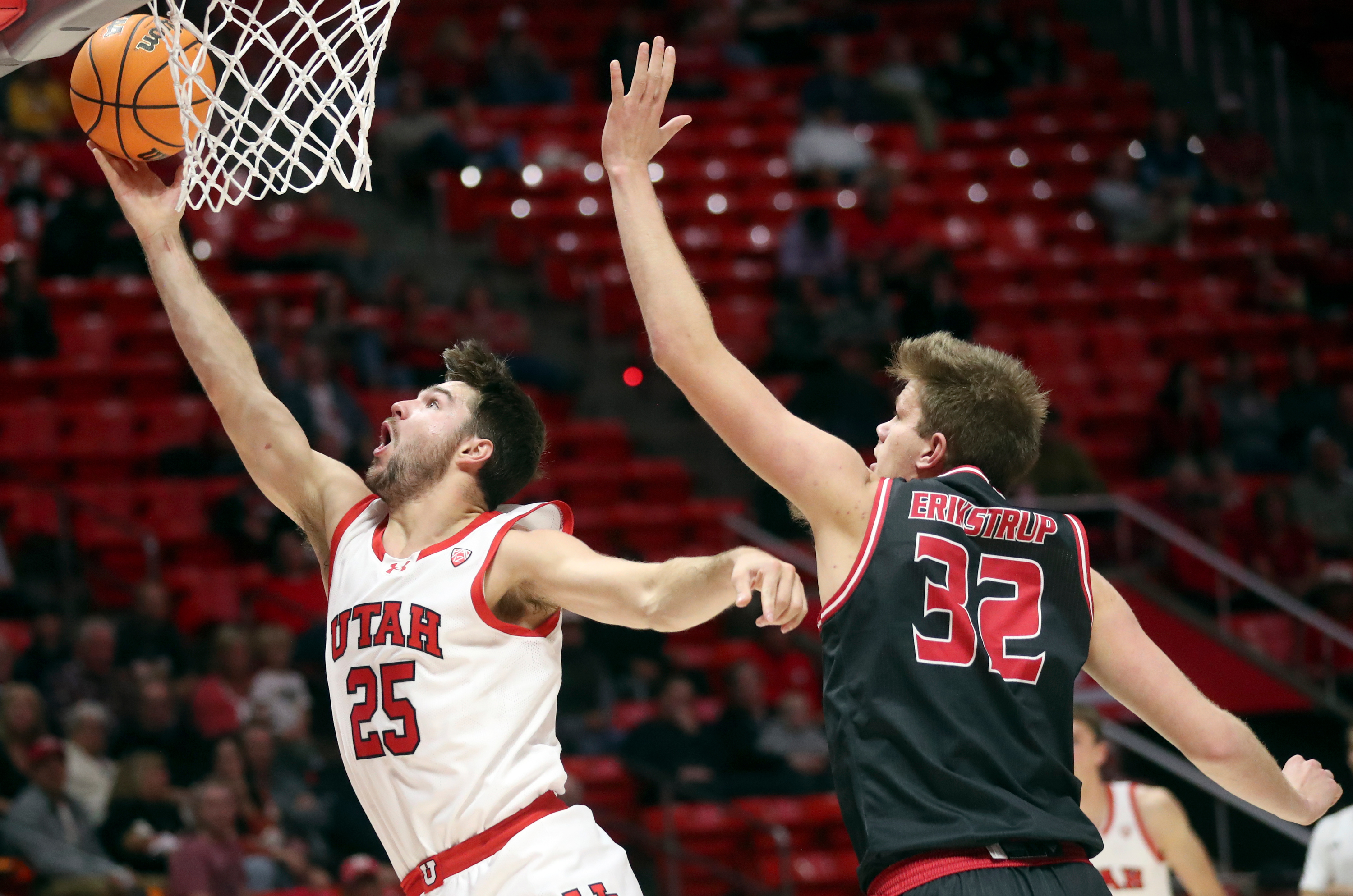 Utah Utes guard Rollie Worster (25) shoots in front of Eastern Washington Eagles forward Dane Erikstrup (32) during a men’s basketball game at the Huntsman Center in Salt Lake City on Monday, Nov. 6, 2023. Utah won 101-66.