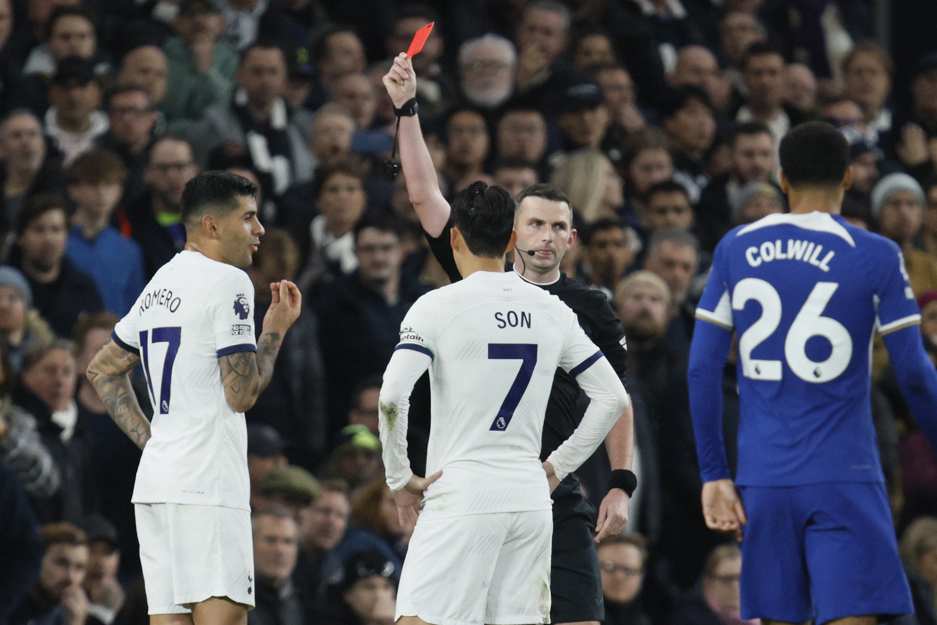 Referee Michael Oliver shows a red card to Tottenham's Cristian Romero during the English Premier League soccer match between Tottenham Hotspur and Chelsea, at Tottenham Hotspur Stadium, London, Monday, Nov. 6, 2023.