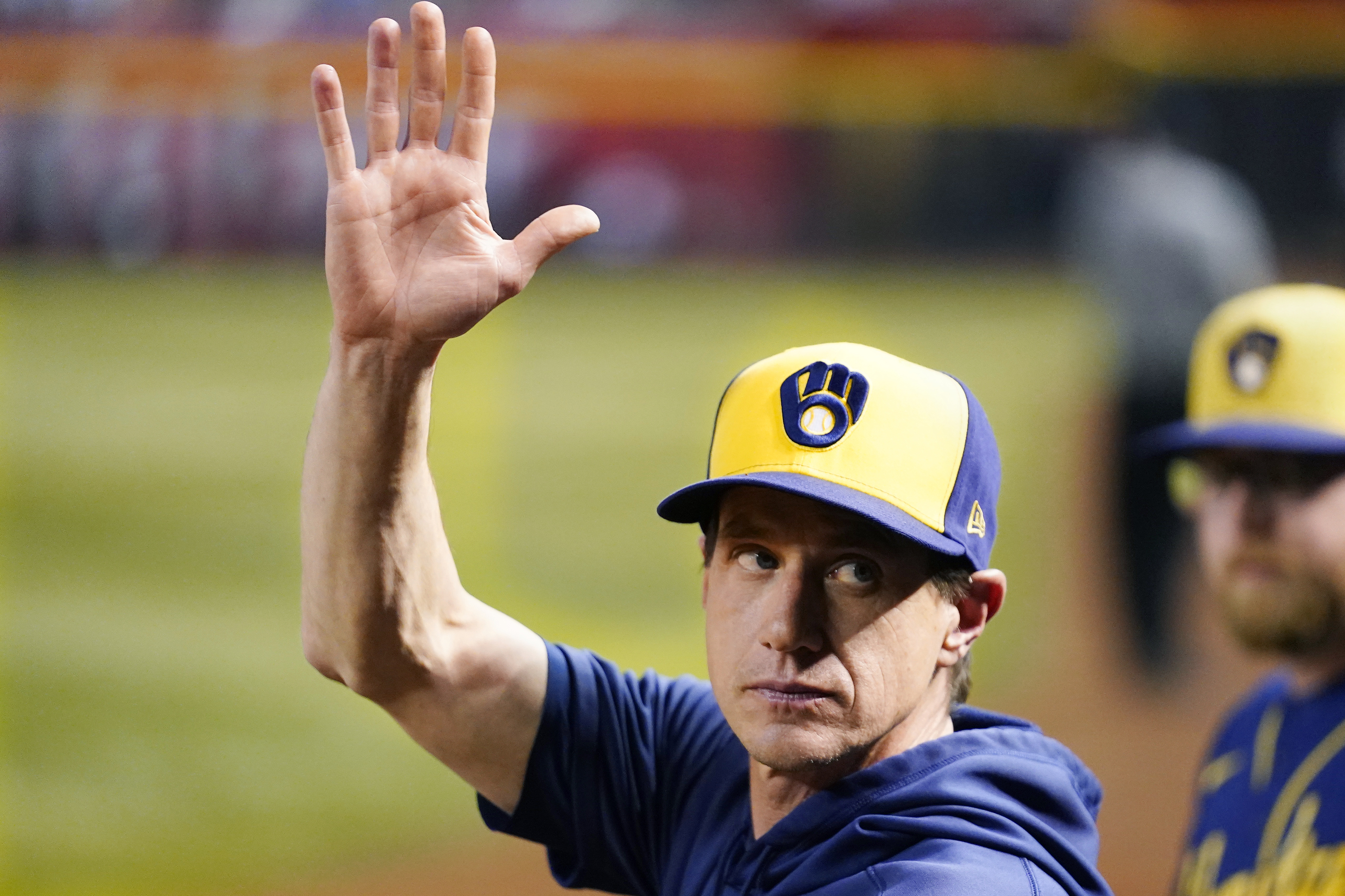 FILE -Milwaukee Brewers manager Craig Counsell waves to the crowd as he is honored as a former Arizona Diamondbacks player, during the fourth inning of the team's baseball game against the Diamondbacks on Tuesday, April 11, 2023, in Phoenix. The first sign of discontent regarding Craig Counsell’s decision to leave the Milwaukee Brewers to manage the Chicago Cubs appeared in his hometown at the Little League field that bears his name.