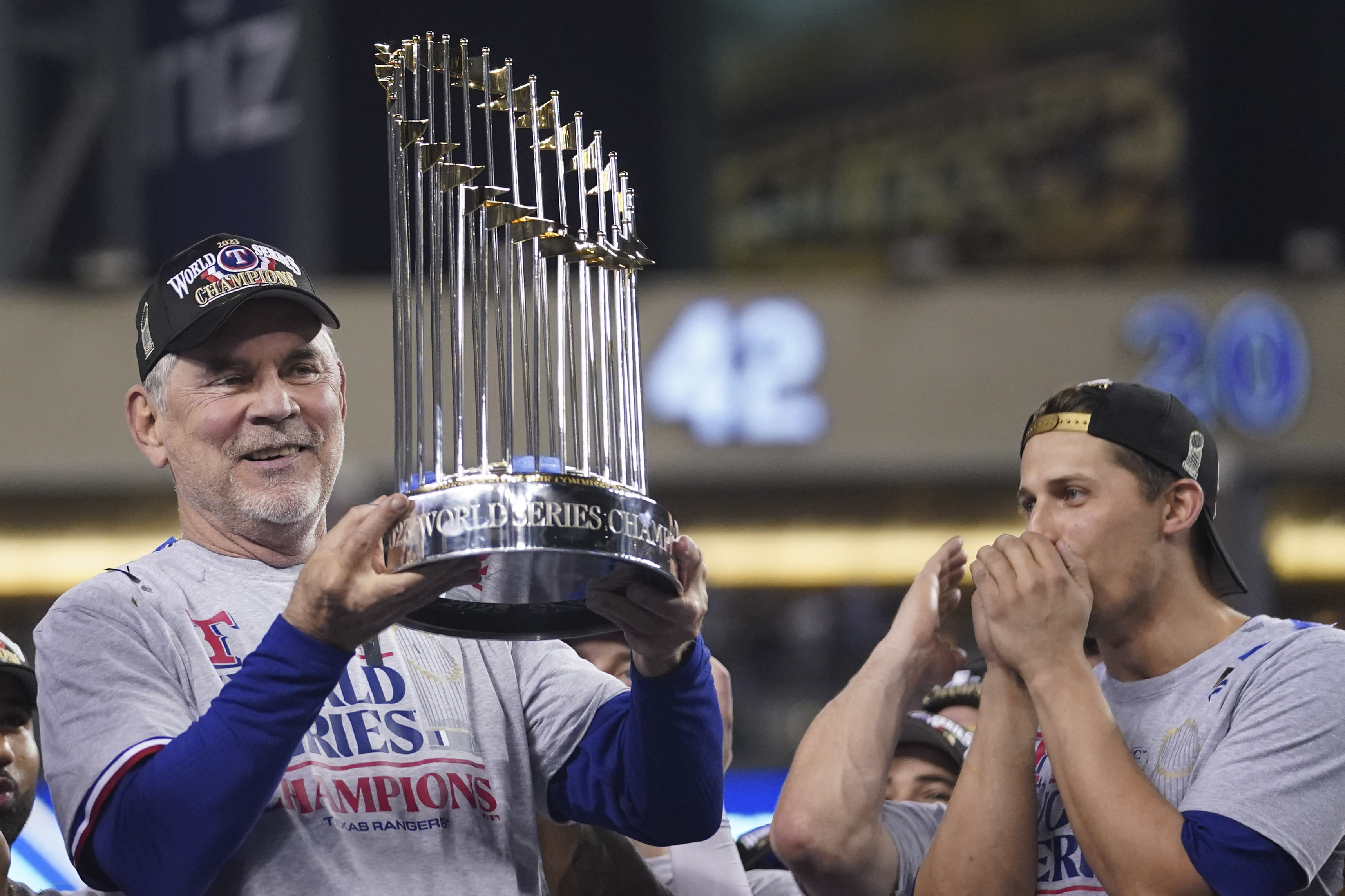 Texas Rangers manager Bruce Bochy holds up the trophy after Game 5 of the baseball World Series against the Arizona Diamondbacks Wednesday, Nov. 1, 2023, in Phoenix. The Rangers won 5-0 to win the series 4-1.