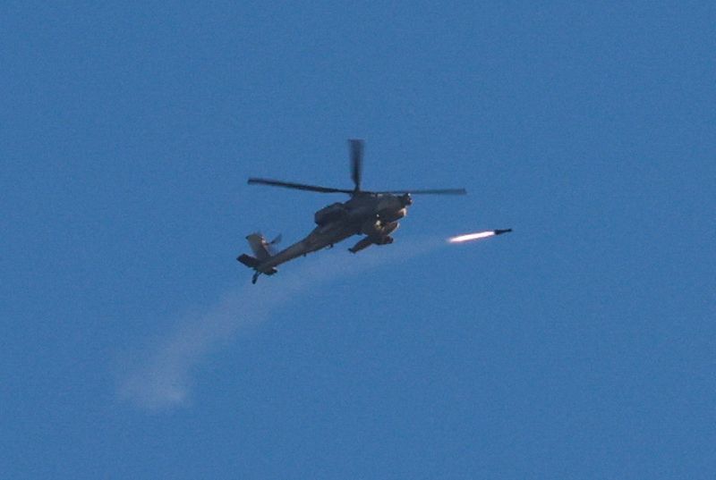 An Apache helicopter fires a missile, amid the ongoing conflict between Israel and Palestinian Islamist group Hamas, as seen from Sderot in southern Israel, Tuesday.