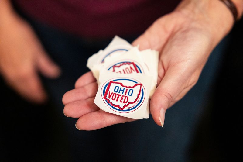 A poll worker holds stickers in Columbus, Ohio, Tuesday. Democrats and abortion rights advocates notched a string of electoral victories on Tuesday, including in conservative Ohio and Kentucky.