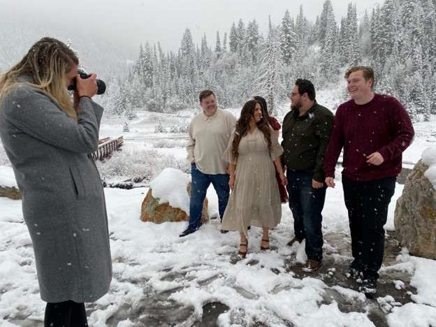 Photographer Brady Anderson takes some family portraits in the wintry conditions in Big Cottonwood Canyon Tuesday. UDOT closed Guardsman Pass early this season due to snow.