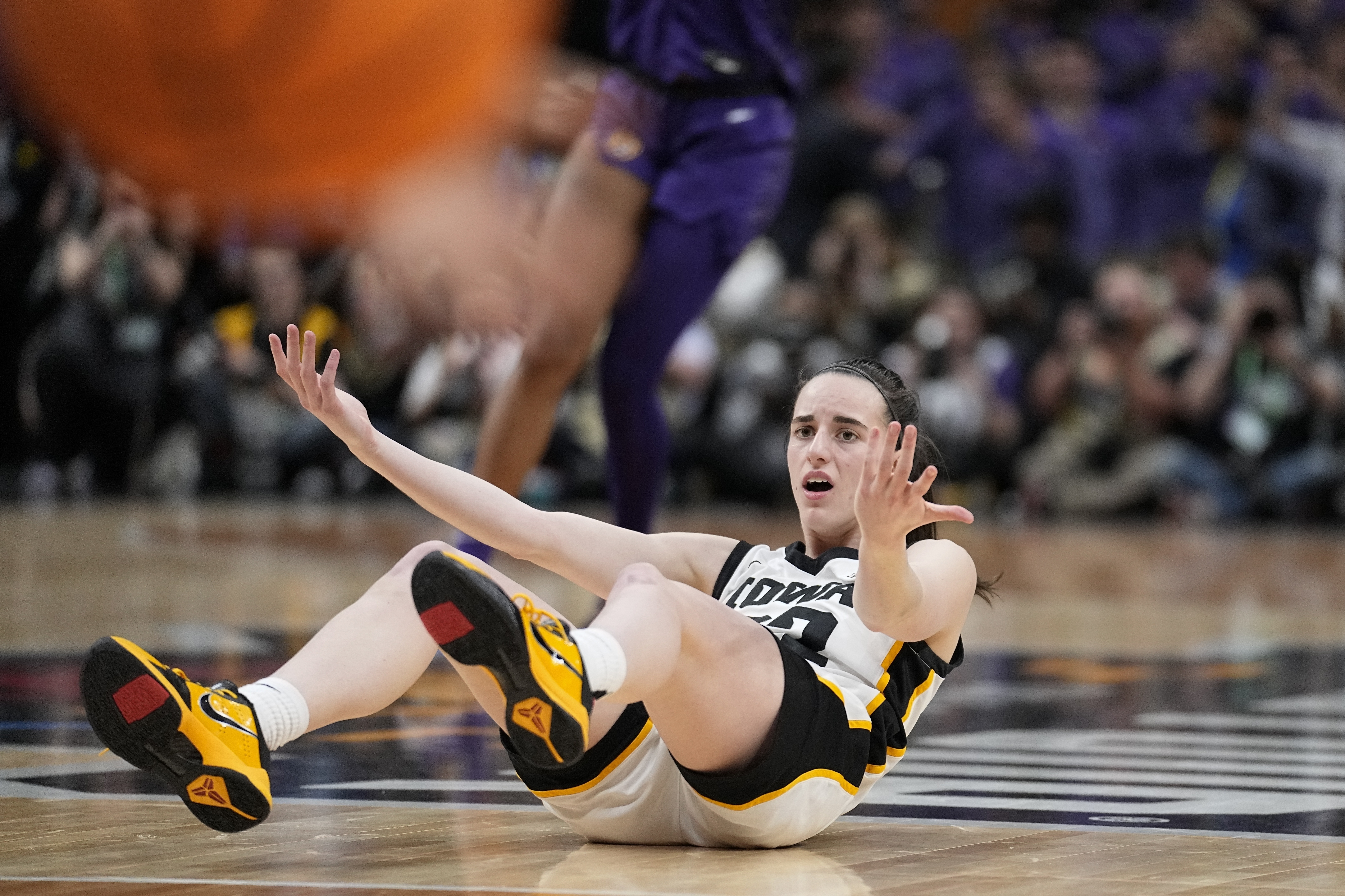 FILE -Iowa's Caitlin Clark looks for a call during the second half of the NCAA Women's Final Four championship basketball game against LSU Sunday, April 2, 2023, in Dallas. The national championship game in women's basketball last spring was unforgettable for a lot of good reasons.The game will also be remembered for its controversial officiating and The Associated Press has learned that an NCAA review concluded the refereeing did not meet expectations. 