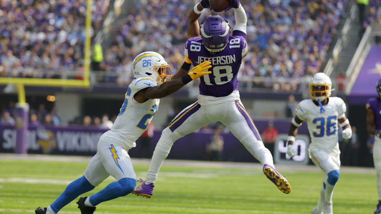 FILE - Minnesota Vikings wide receiver Justin Jefferson (18) catches a pass over Los Angeles Chargers cornerback Asante Samuel Jr. (26) during the first half of an NFL football game, Sept. 24, 2023, in Minneapolis. The Vikings designated wide receiver Jefferson for return from injured reserve Wednesday, Nov. 8, bringing the 2022 NFL Offensive Player of the Year back to practice with three weeks to assess the readiness of his strained right hamstring for game action.