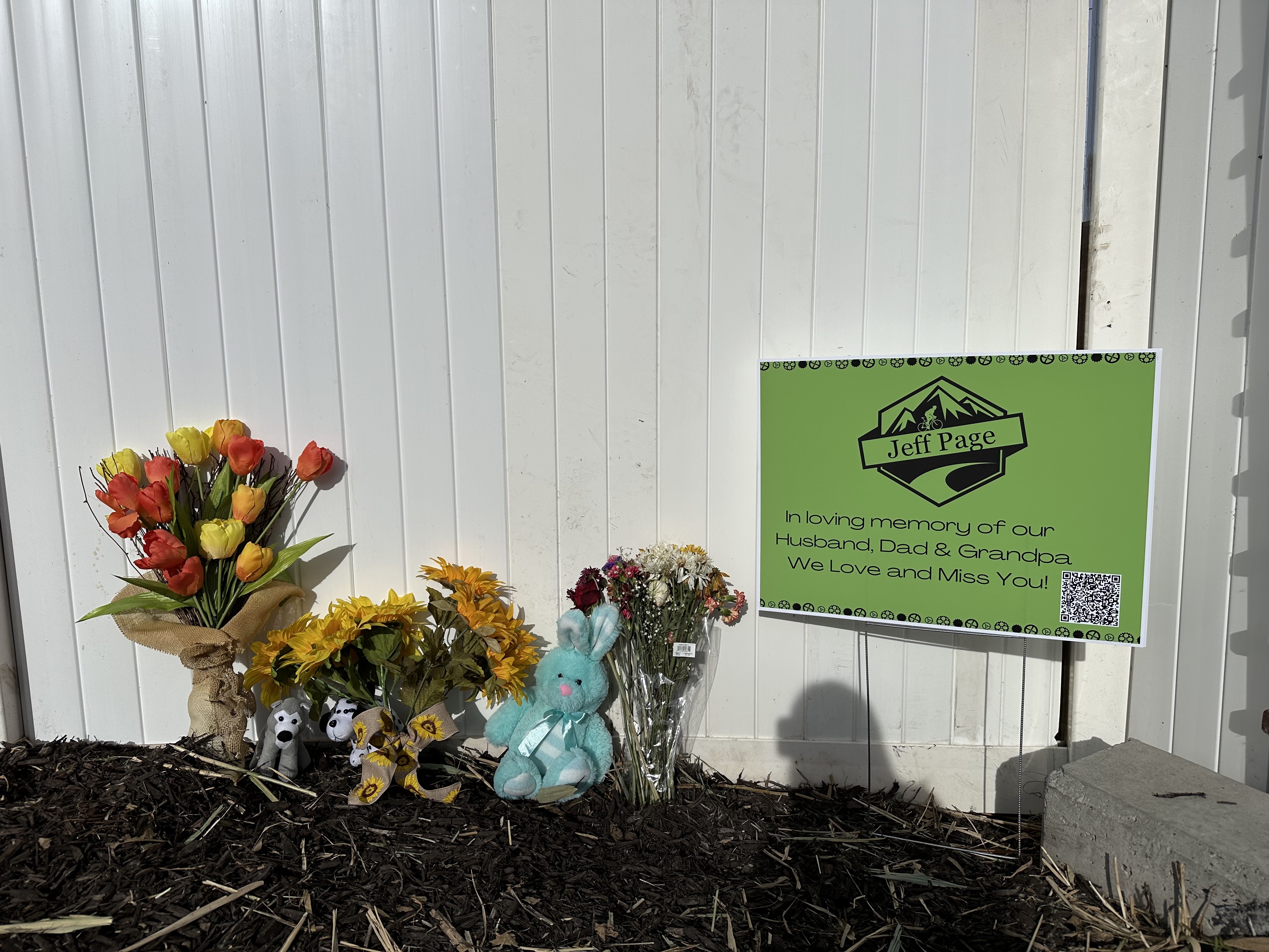 Flowers and a sign honor Jeff Page, who died on Halloween in a biking accident near the Jordan River Trailhead in West Jordan.