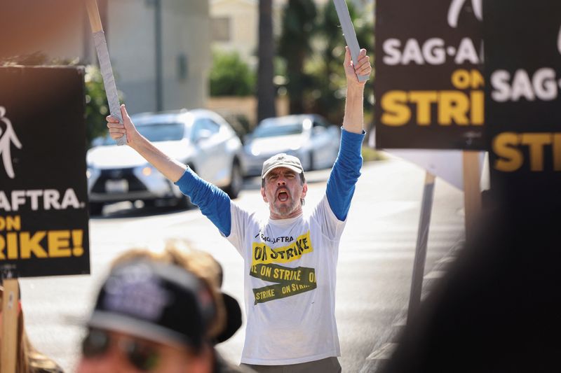 Jim Kulick reacts as he and other SAG-AFTRA members walk the picket line on the 100th day of their strike on Oct. 20. The SAG-AFTRA actors' union reached a tentative agreement with Hollywood studios Wednesday.