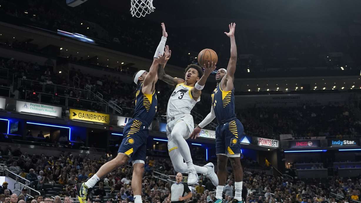 Utah Jazz's Keyonte George (3) shoots against Indiana Pacers' Andrew Nembhard, left, and Buddy Hield (7) during the second half of an NBA basketball game, Wednesday, Nov. 8, 2023, in Indianapolis.