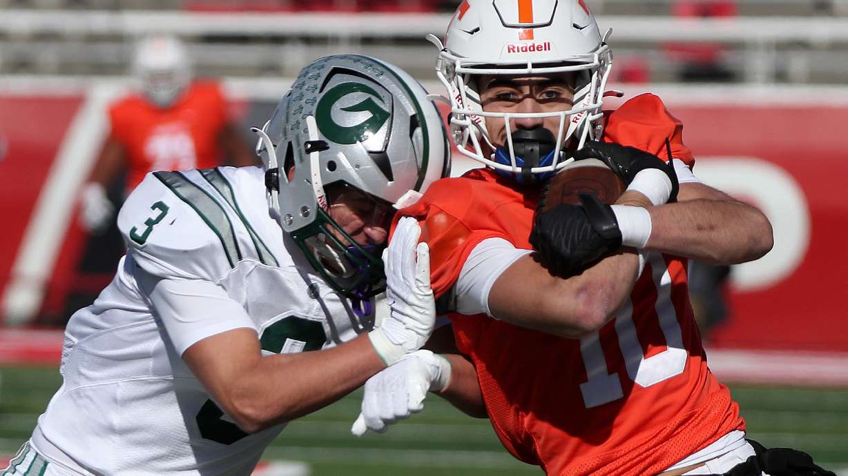 Olympus High’s Ryan Reynard pushes Timpview’s Tei Nacua out of bounds during a 5A football state semifinal game at Rice-Eccles Stadium in Salt Lake City on Thursday, Nov. 9, 2023. Timpview won 22-20.