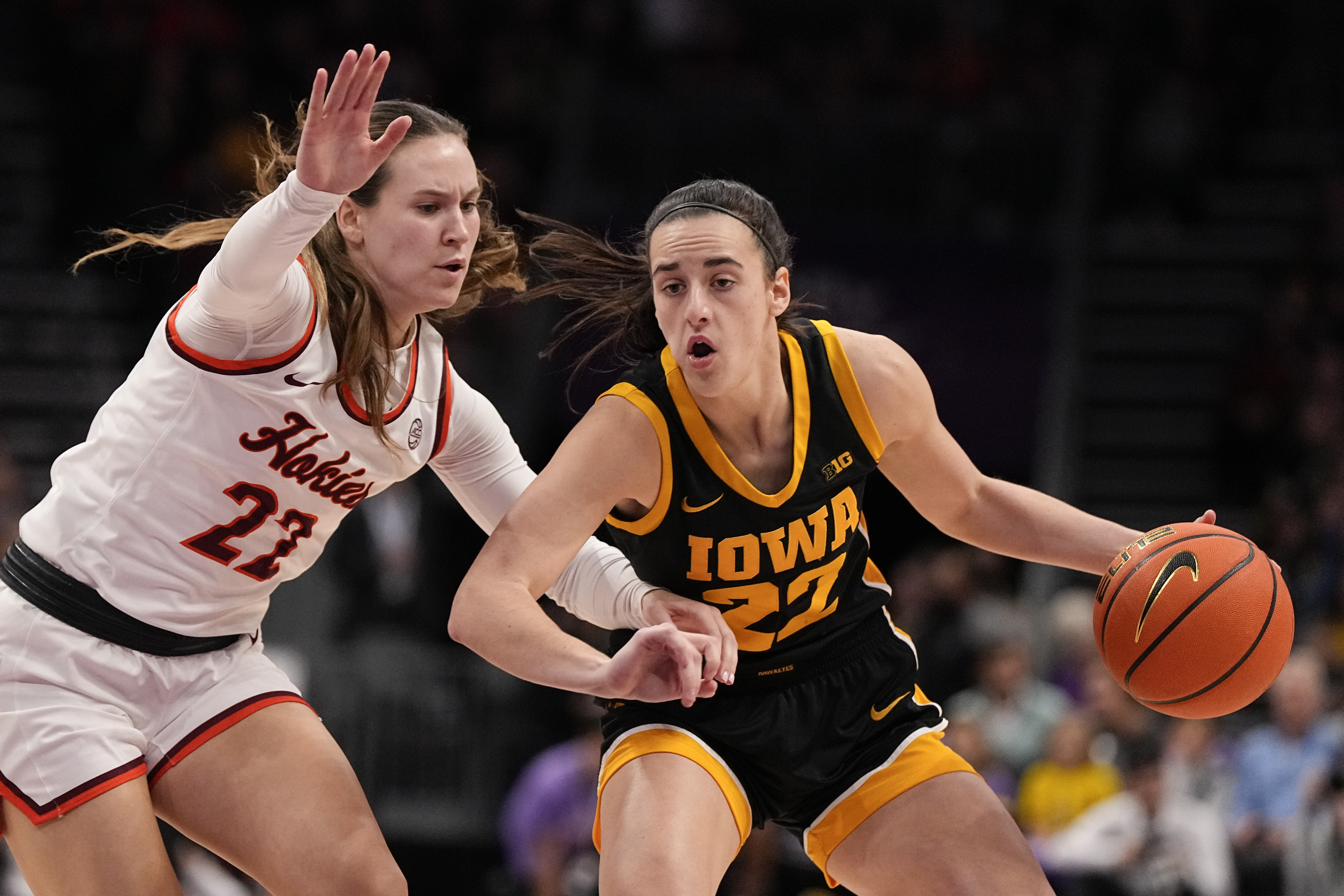 Iowa guard Caitlin Clark, right, drives to the basket past Virginia Tech guard Cayla King during the first half of an NCAA women's college basketball game Thursday, Nov. 9, 2023, in Charlotte, N.C.