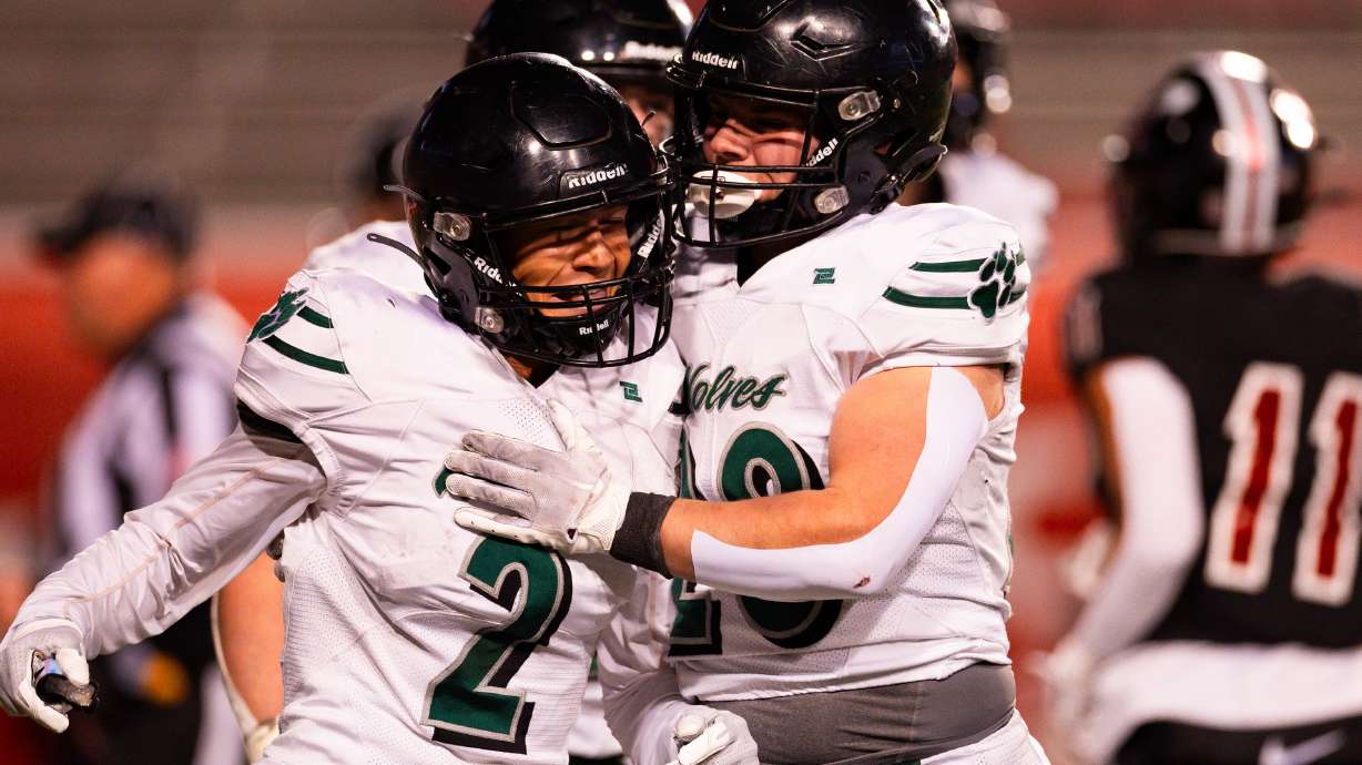 Green Canyon High School’s Eric Oates, right, celebrates with teammate Dewey Egan after Egan’s touchdown during the 4A football state semifinal game against Park City High School at Rice-Eccles Stadium in Salt Lake City on Thursday, Nov. 9, 2023.