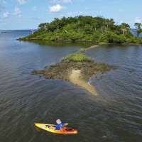 The Great Grift: COVID-19 aid thieves bought fancy cars, a Pokemon card — even a private island