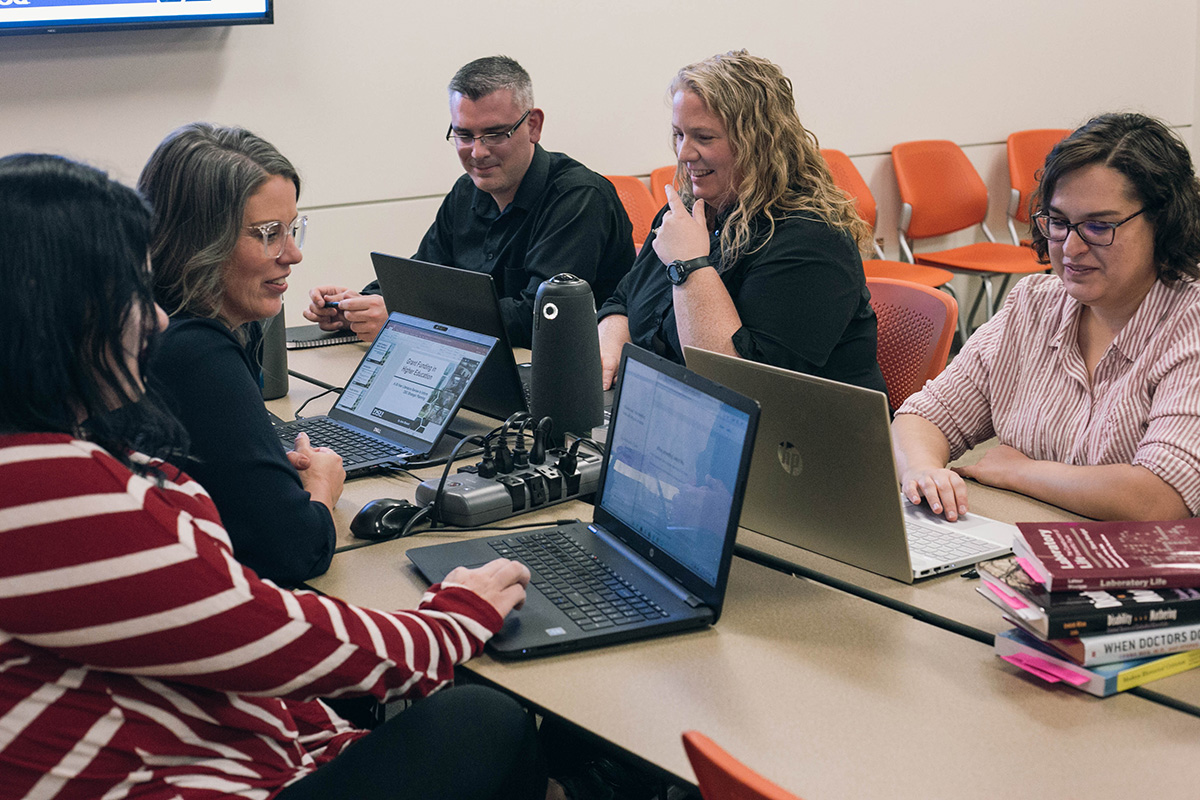 Picture of the Critical Theories class, Fall 2019 (the program's first semester). April Vevea, Professor Joy McMurrin, Logan Anderson, Jenn Stewart, and Haley Evans are pictured; not pictured is Karen McMullin, who joined the class remotely from Farmington, Utah.