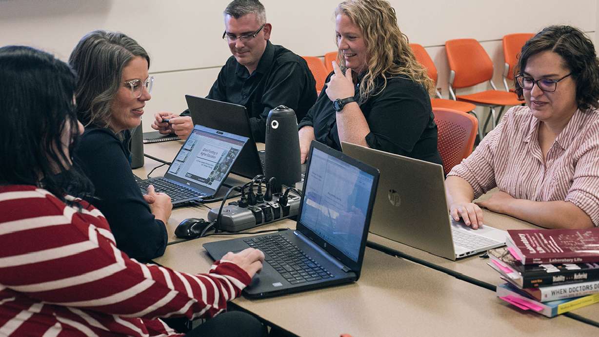 Picture of the Critical Theories class, Fall 2019 (the program's first semester). April Vevea, Professor Joy McMurrin, Logan Anderson, Jenn Stewart, and Haley Evans are pictured; not pictured is Karen McMullin, who joined the class remotely from Farmington, Utah.