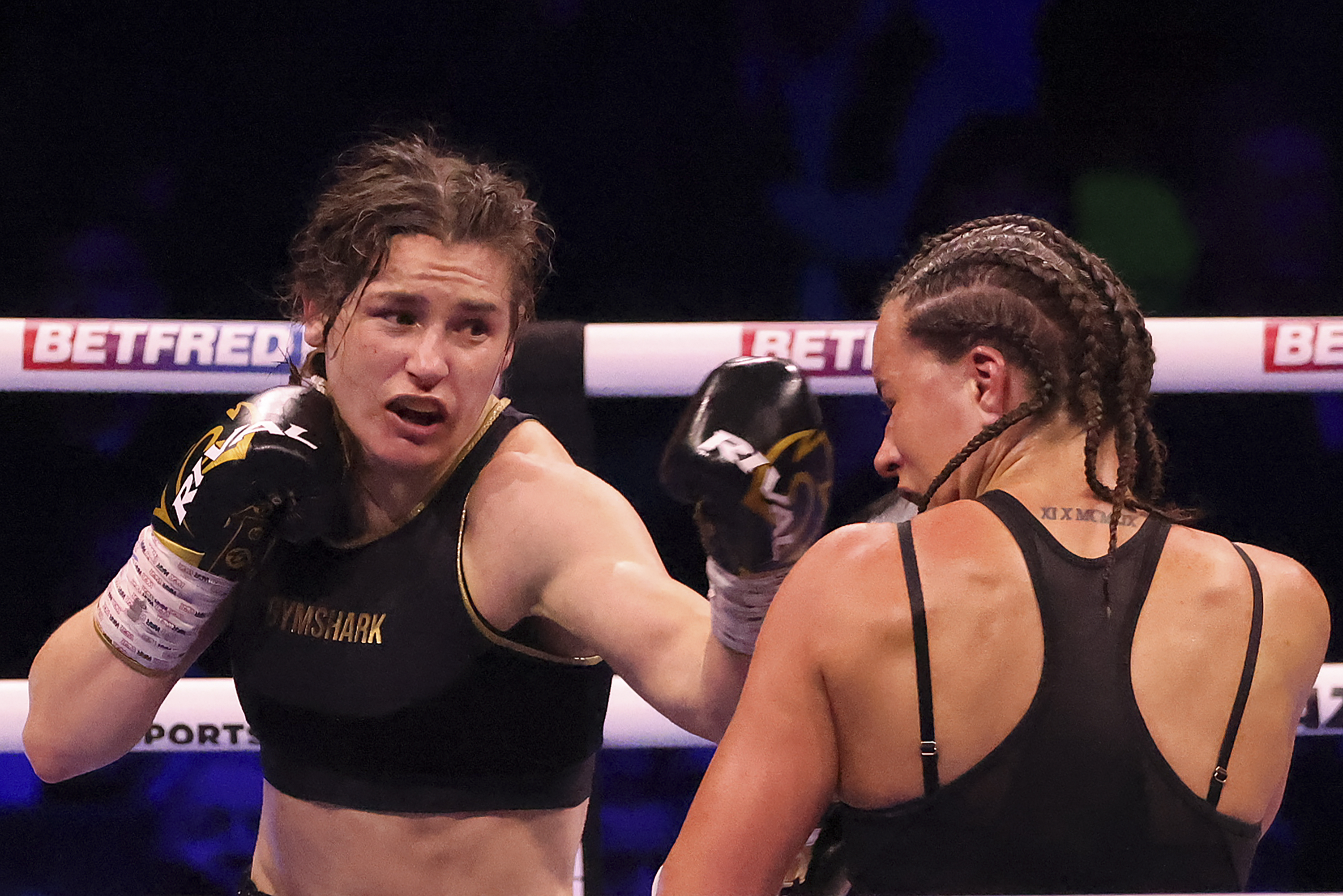 FILE - Ireland's Katie Taylor, left, lands a punch on Britain's Chantelle Cameron during their light-welterweight boxing world title fight at the 3Arena in Dublin, Ireland, Saturday, May 20, 2023. Undisputed lightweight champion Katie Taylor questioned whether women's boxing has the “strength and depth” to move to 3-minute rounds. The Irish fighter will try to avenge the only loss of her professional career when she faces Chantelle Cameron this month in a rematch of their fight in May. 