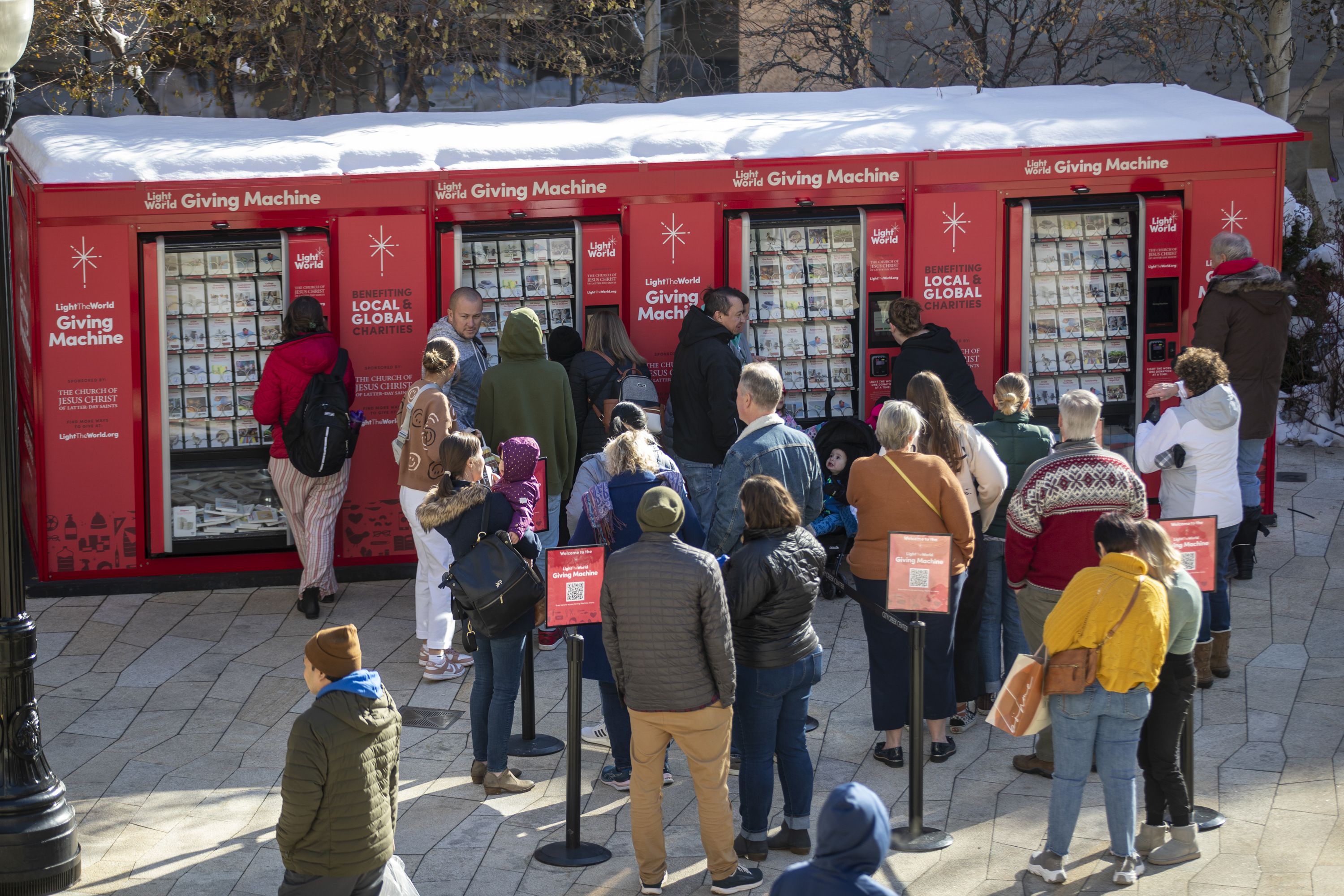 People line up at Giving Machines at City Creek Center in Salt Lake City in 2022. The machines at malls in Salt Lake City and Orem open on Monday and stay open through early January, with others in Utah open during different windows.