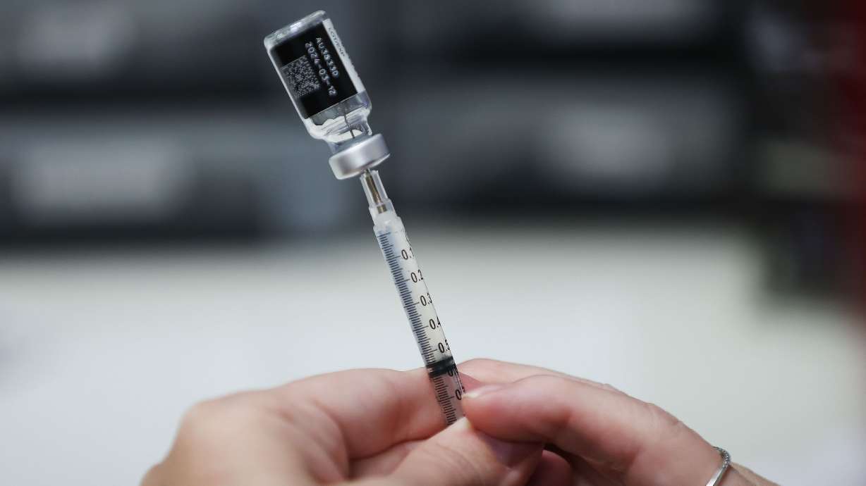 A COVID-19 vaccine is drawn at Salt Lake County Health Center in Salt Lake City on Oct. 4. The number of kids whose parents opted them out of state-required childhood vaccinations has reached an all-time high.