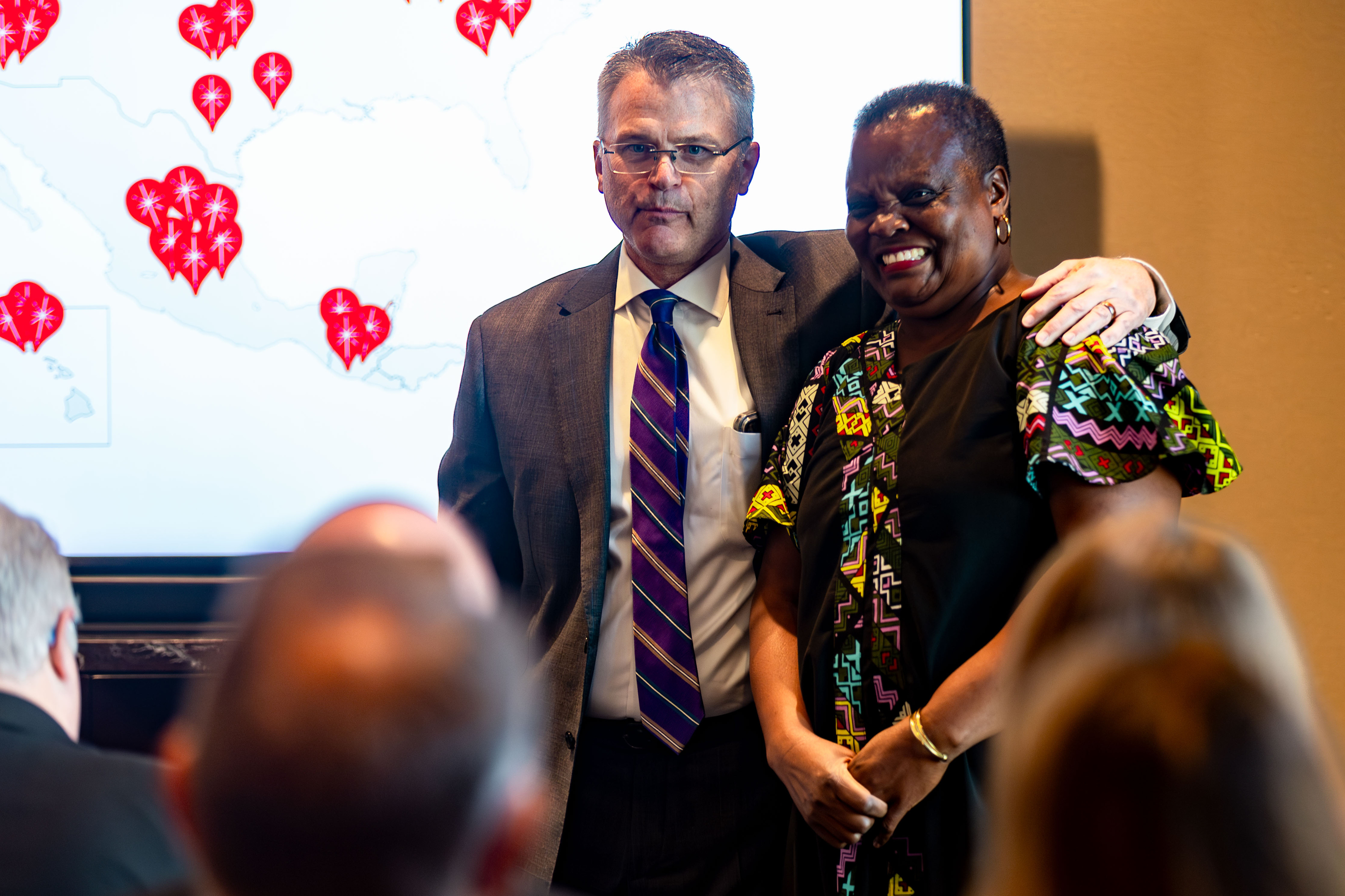 Karl Cheney introduces Mary Concepter Obiero, director of relief development and protection for Church World Service Africa, at an announcement about the annual giving machines sponsored by The Church of Jesus Christ of Latter-day Saints at the Conference Center on Friday.