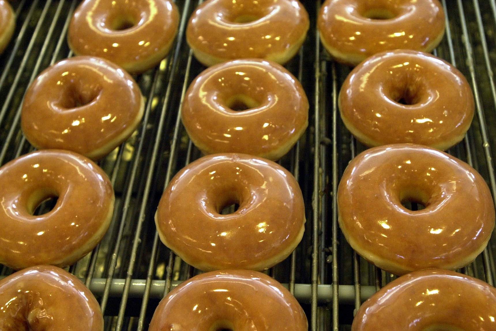 Doughnuts travel along a conveyor belt to be boxed for customers at the Krispy Kreme doughnut shop in Orem on Dec. 29, 2000. To celebrate Veterans Day, several restaurants are offering deals and freebies for veterans and military personnel.