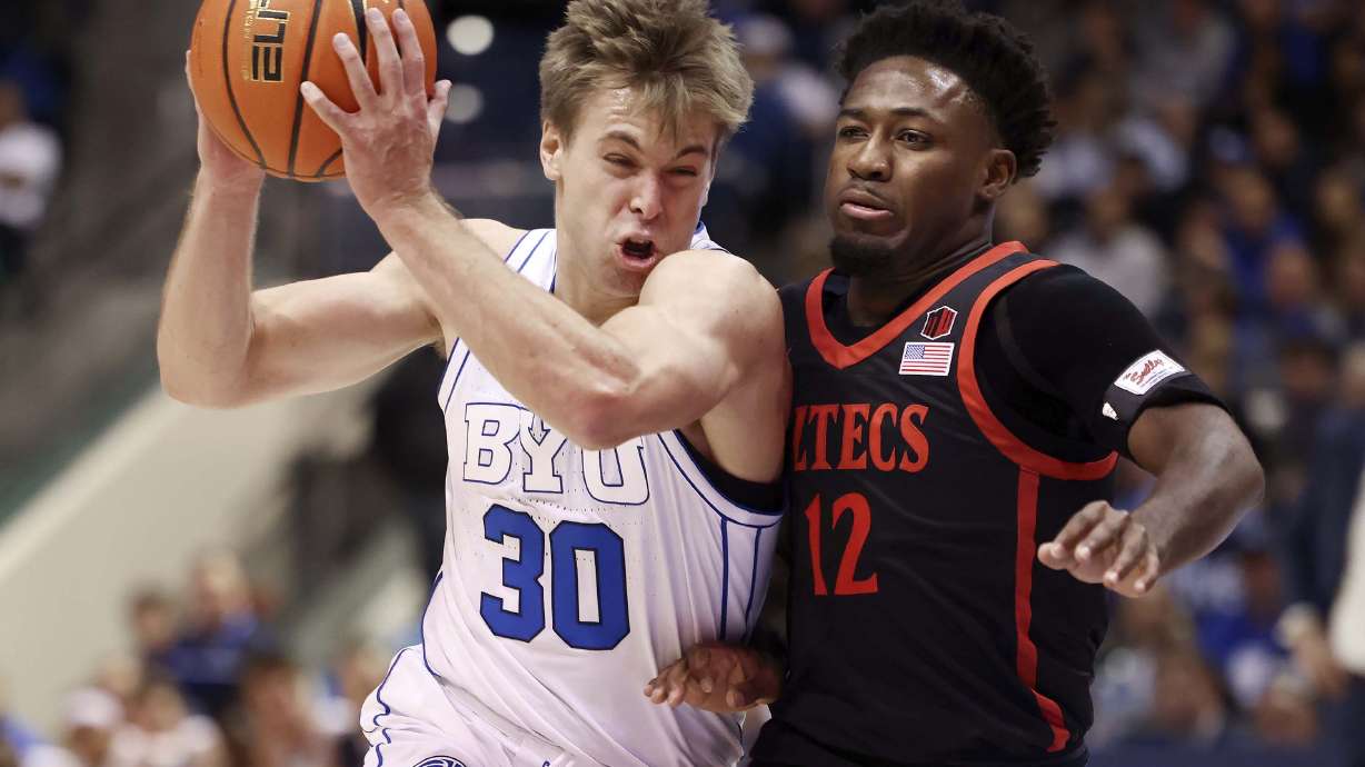 Brigham Young guard Dallin Hall (30) drives into San Diego State guard Darrion Trammell (12) as BYU and San Diego State compete at BYU’s Marriott Center in Provo on Friday, Nov. 10, 2023.