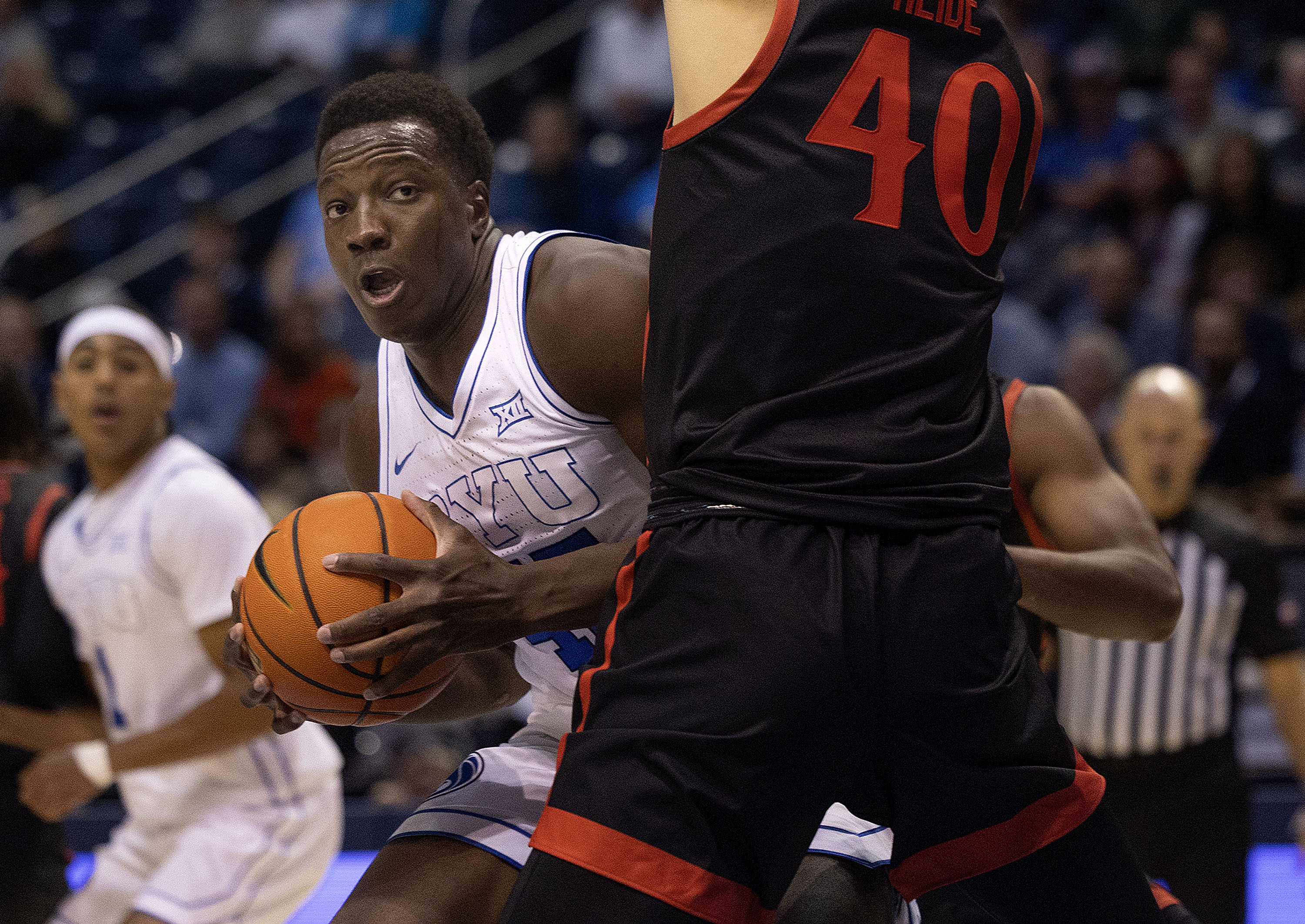 Brigham Young forward Fousseyni Traore (45) drives into San Diego State Aztecs forward Miles Heide (40) at BYU’s Marriott Center in Provo on Friday, Nov. 10, 2023.