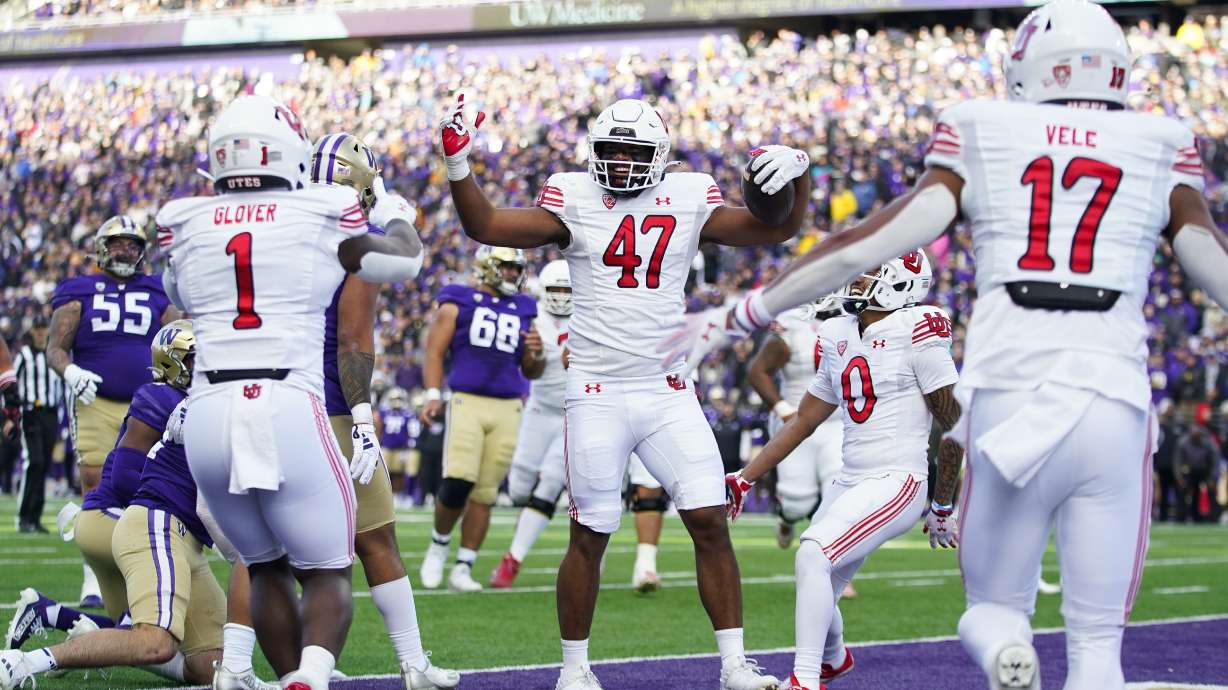 Utah tight end Miki Suguturaga (47) celebrates scoring a touchdown with running back Jaylon Glover (1) and wide receiver Devaughn Vele (17) during the first half of an NCAA college football game against Washington, Saturday, Nov. 11, 2023, in Seattle.