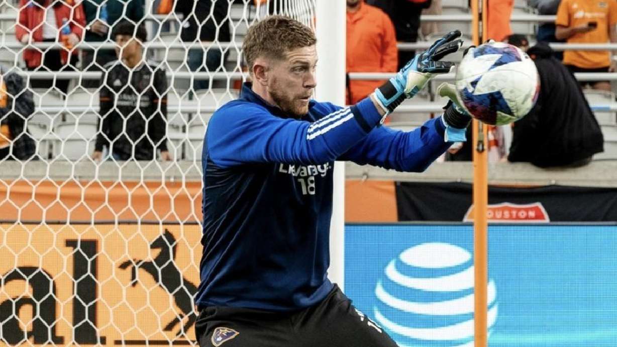 Zac MacMath stops a shot during warm-ups in Houston.