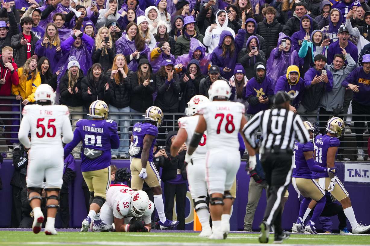 Utah offensive lineman Michael Mokofisi (52) recovers a fumble by Washington linebacker Alphonzo Tuputala (11) after Tuputala dropped the football while celebrating his interception before reaching the end zone, during the second half of an NCAA college football game Saturday, Nov. 11, 2023, in Seattle. Washington won 35-28.
