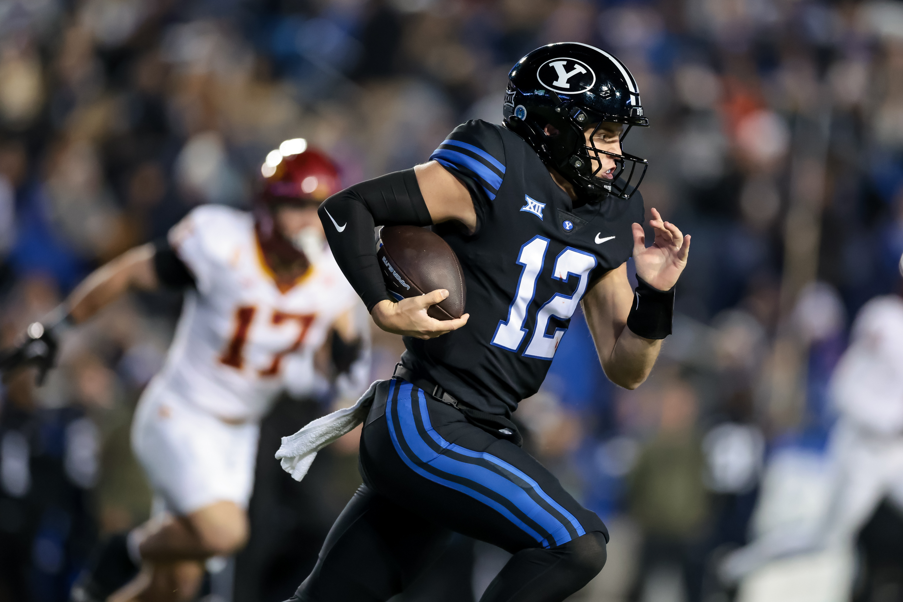 BYU quarterback Jake Retzlaff (12) runs the ball during the game against the Iowa State at LaVell Edwards Stadium in Provo on Saturday, Nov. 11, 2023.