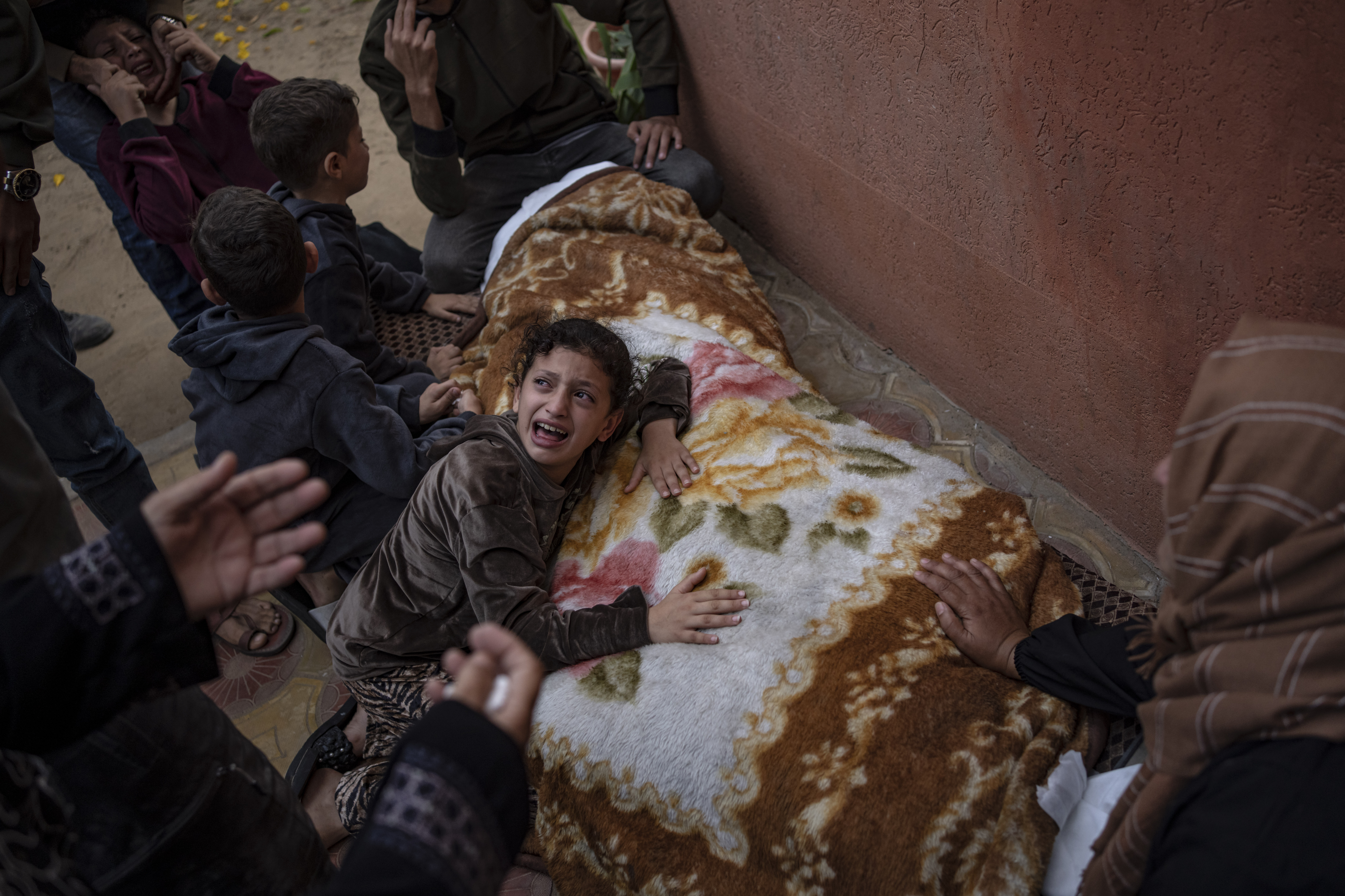Palestinians mourn their relatives killed in the Israeli bombardment of the Gaza Strip, in the hospital in Khan Younis, Saturday. Health officials and people trapped inside Gaza's largest hospital are rejecting Israel's claims that it is helping babies and others evacuate.