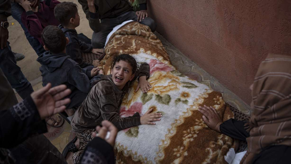 Palestinians mourn their relatives killed in the Israeli bombardment of the Gaza Strip, in the hospital in Khan Younis, Saturday. Health officials and people trapped inside Gaza's largest hospital are rejecting Israel's claims that it is helping babies and others evacuate.