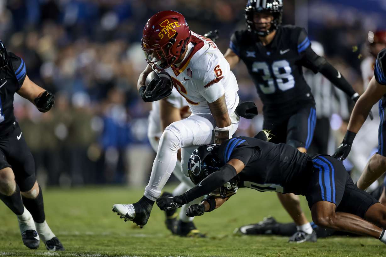 Iowa State running back Eli Sanders (6) evades the tackle from BYU cornerback Jakob Robinson (0) during the game at LaVell Edwards Stadium in Provo on Saturday, Nov. 11, 2023.