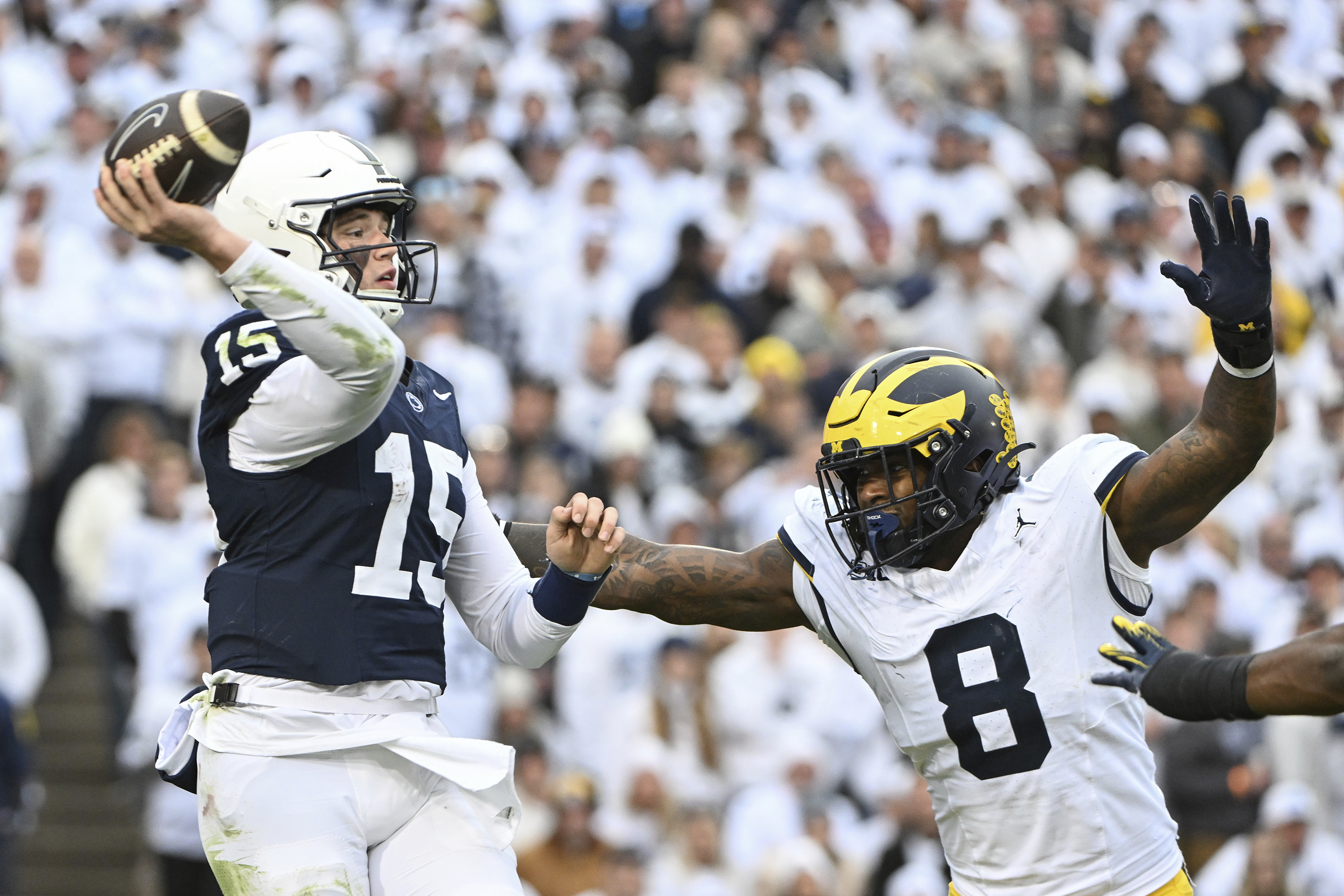 Michigan defensive end Derrick Moore (8) pressures Penn State quarterback Drew Allar (15) during the second half of an NCAA college football game, Saturday, Nov. 11, 2023, in State College, Pa. 