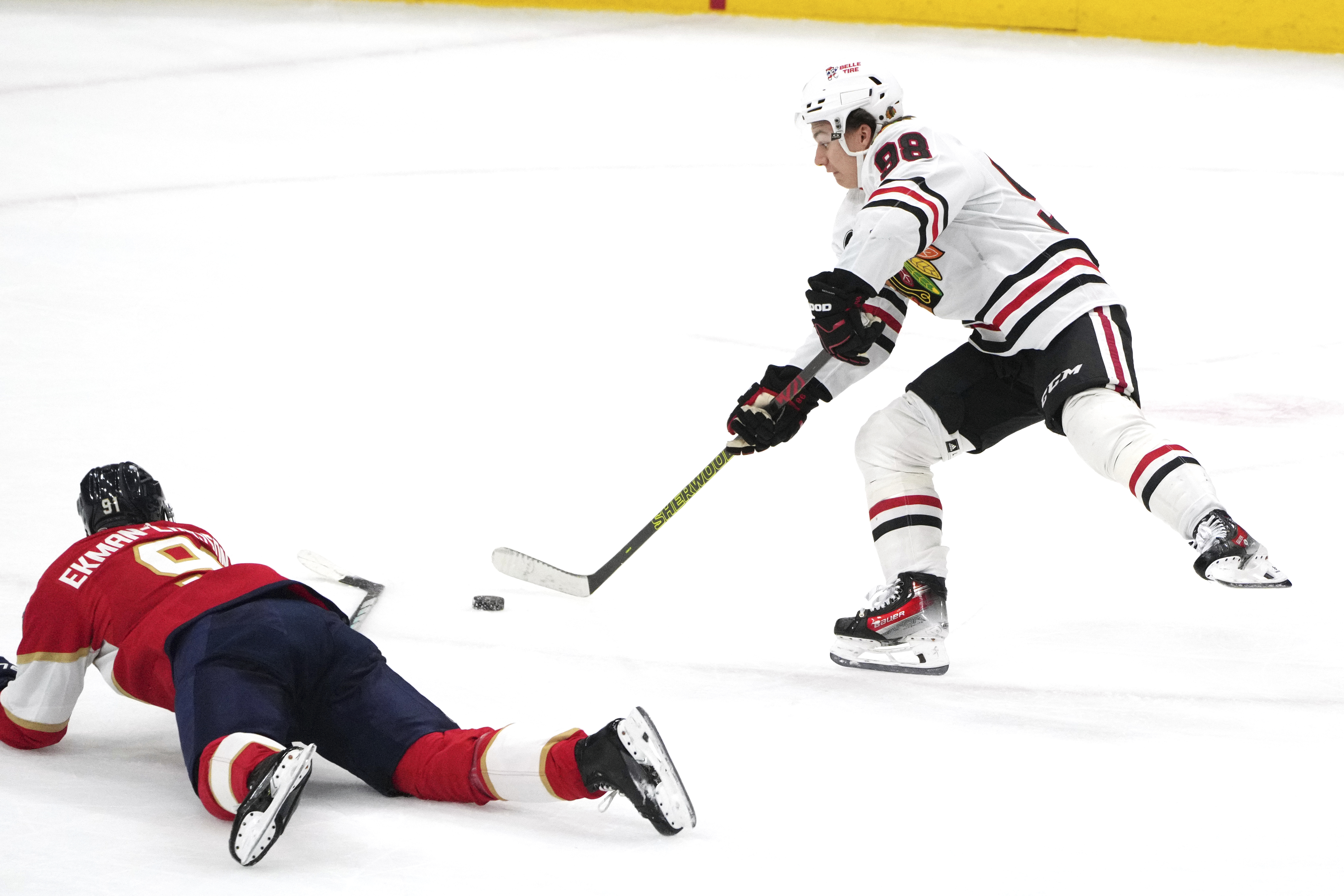 Chicago Blackhawks center Connor Bedard (98) takes a shot as Florida Panthers defenseman Oliver Ekman-Larsson (91) defends on the play during the second period of an NHL hockey game Sunday, Nov. 12, 2023, in Sunrise, Fla. 