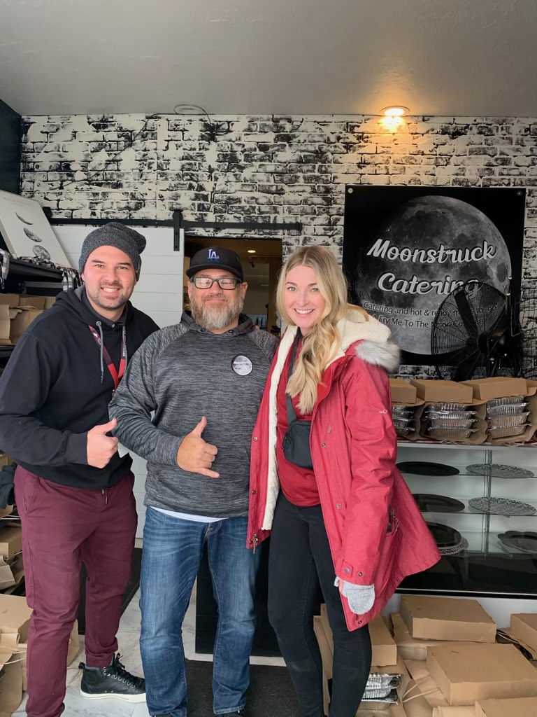 Ian Pizarro with his wife, Brittany Pizarro, and the owner at Moonstruck Catering. Ian Pizarro survived an aortic dissection in November 2014. As a way to show gratitude, he provides Thanksgiving meals for families in need.