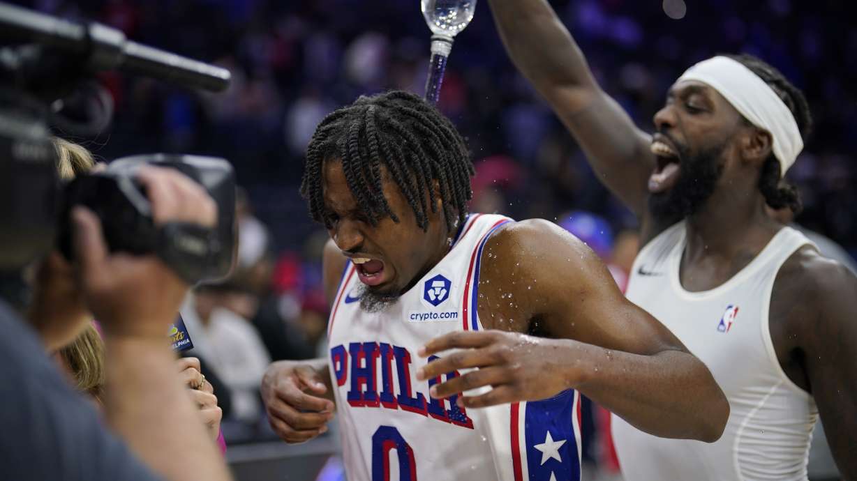 Philadelphia 76ers' Tyrese Maxey, center, is doused by Patrick Beverley after an NBA basketball game against the Indiana Pacers, Sunday, Nov. 12, 2023, in Philadelphia.