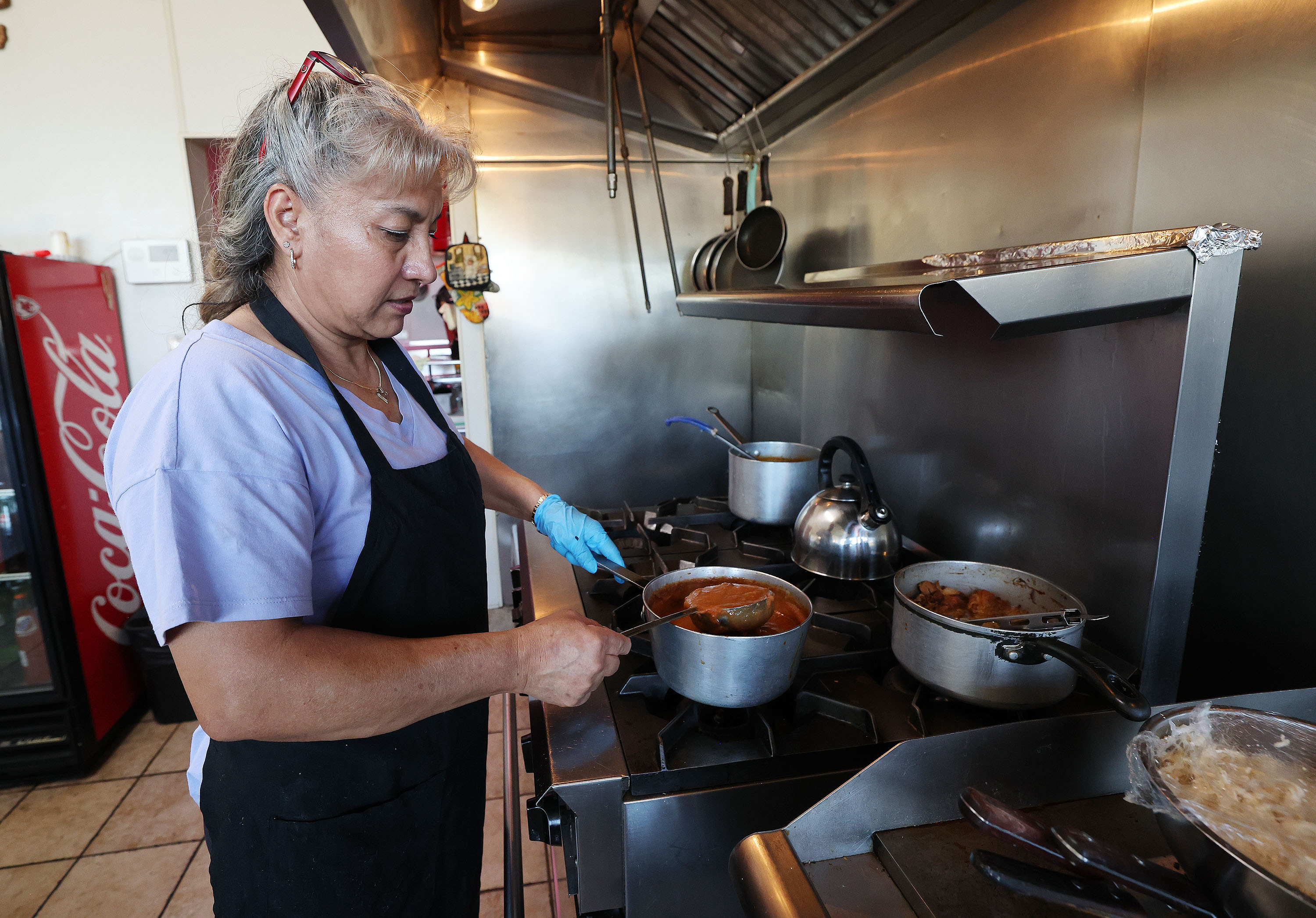 Imelda Morales prepares food at their restaurant El Asadero in Salt Lake City on Oct. 27. The restaurant will be displaced by a new apartment complex.